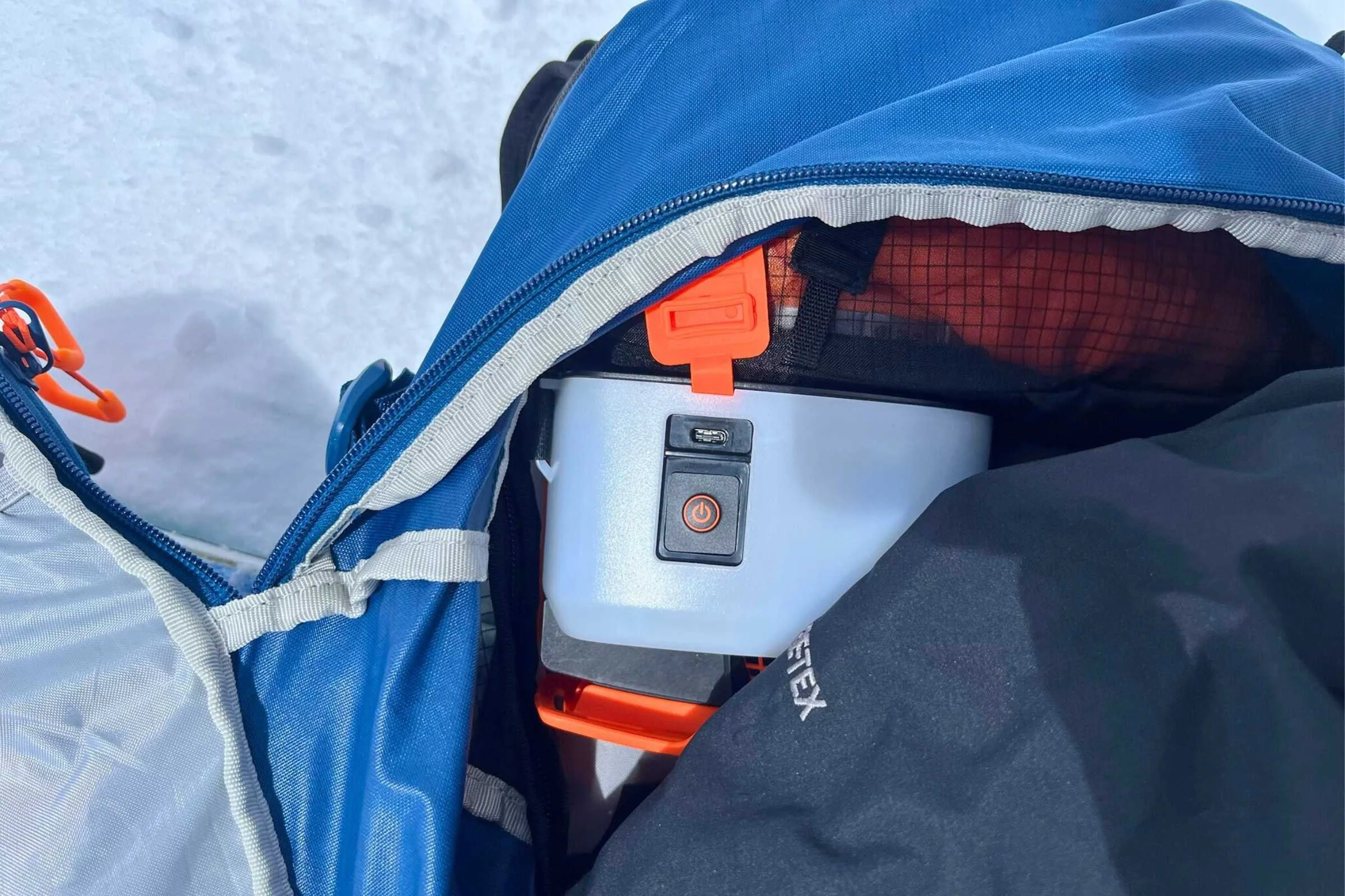   The LiTRIC airbag system doesn’t take up much space in the AVABAG TOUR at all. The orange cover makes sure you can’t turn it off while using the pack.  