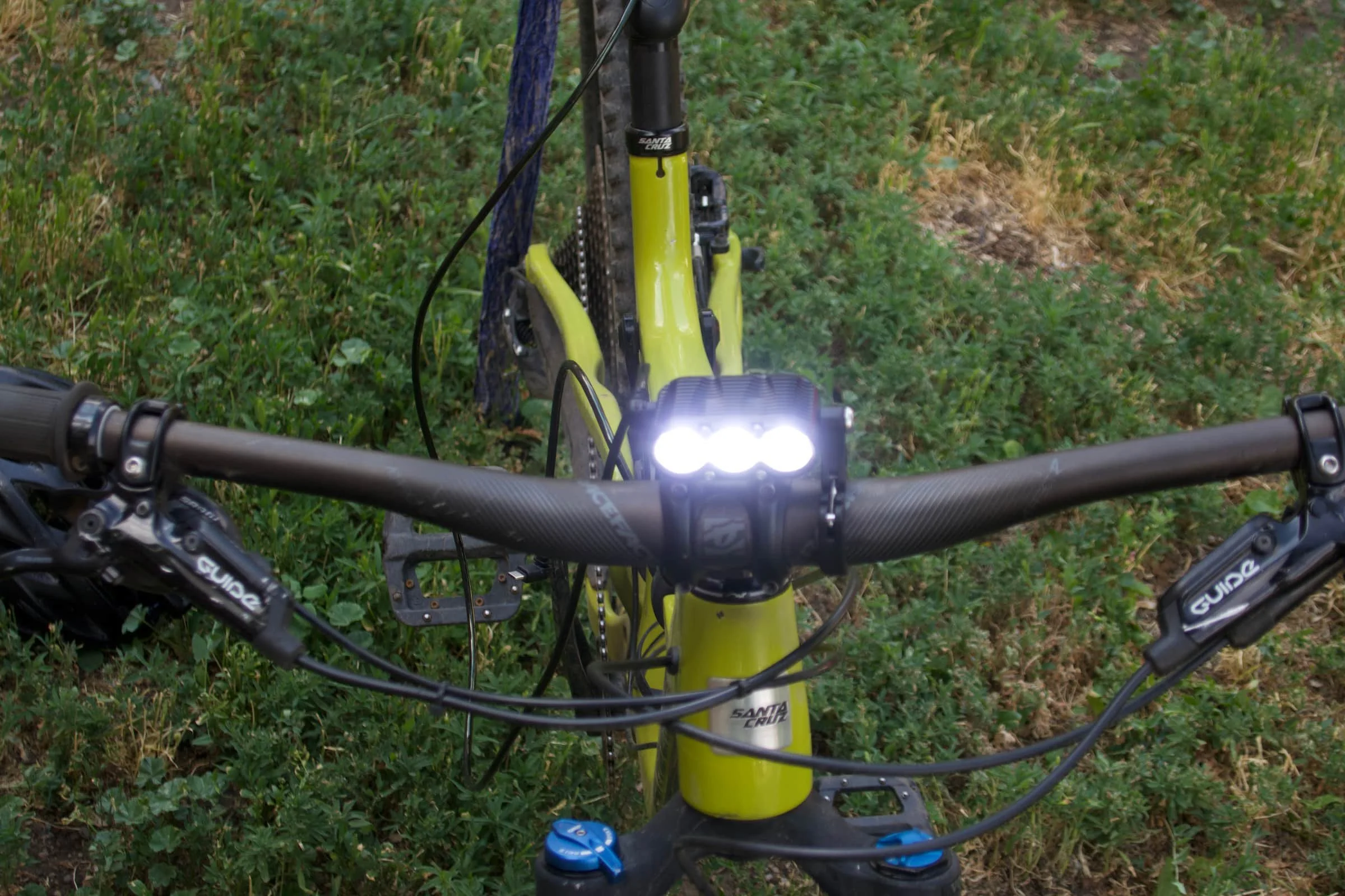   The Gloworm XS mounts on either your handlebars or helmet, though we preferred using it as a bar light (shown here).   Photo by Chris Meehan.   