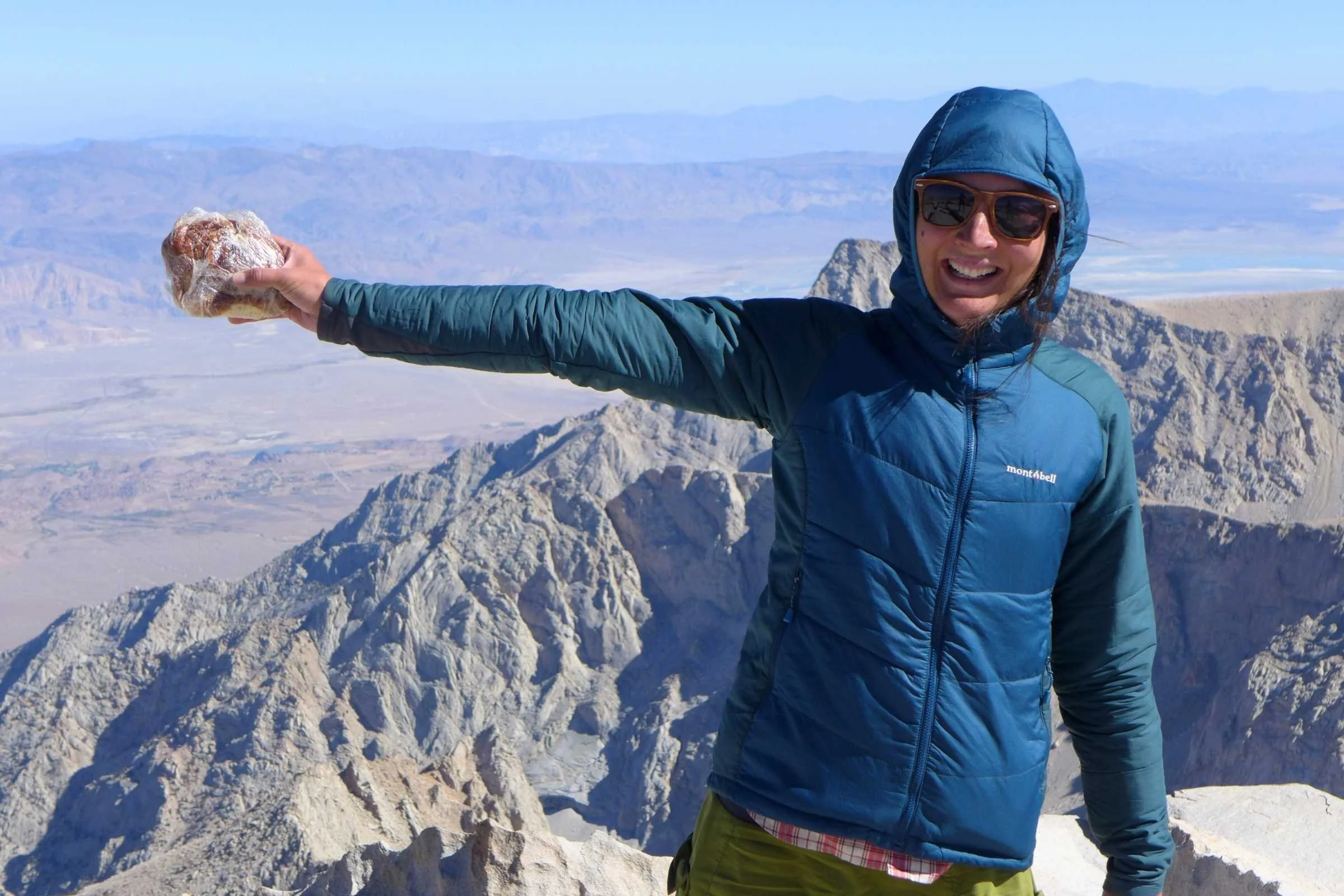   Treeline editor Liz Thomas wearing the Montbell Thermawrap jacket on top of Mt. Whitney at the terminus of a thru-hike from Badwater in Death Valley.  Photo by Kate Hoch. 