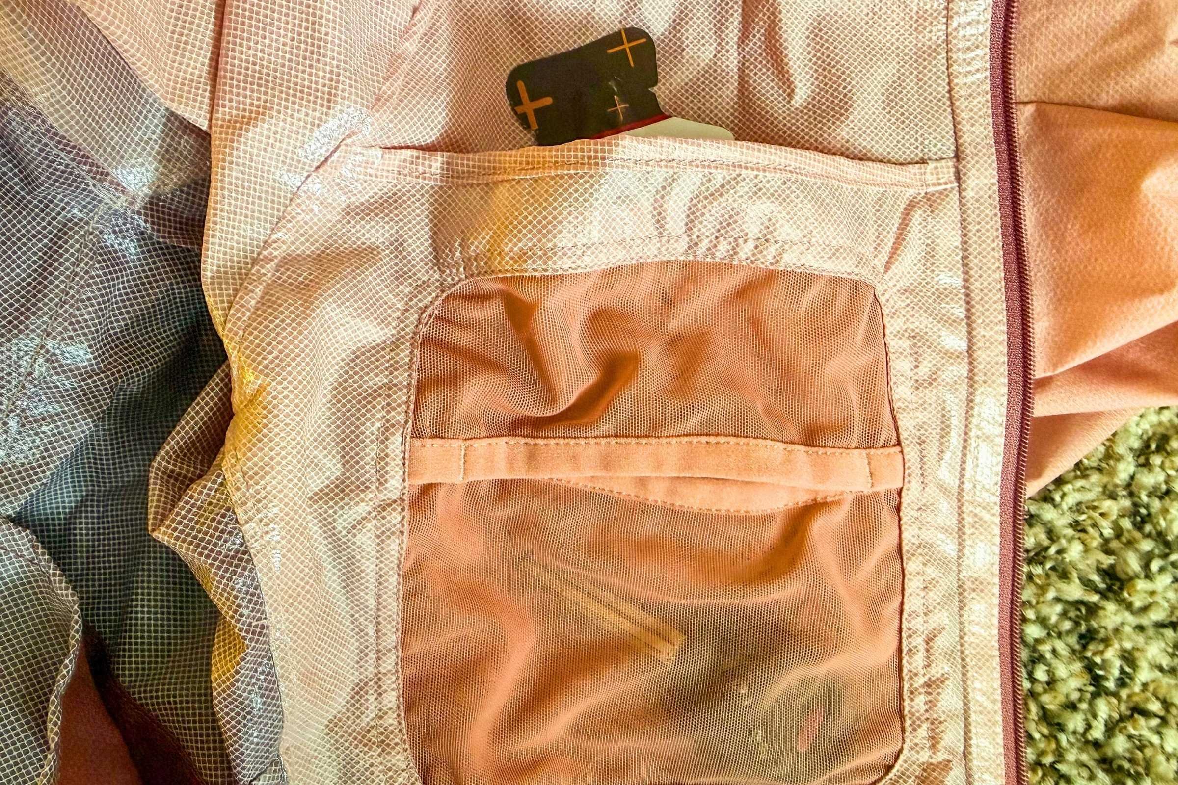   The dual interior pocket of the Ultimate Direction Ultra Jacket is spacious, but doesn’t securely close. Here you see plenty of room for fuel and a car key.   Photo by Becca Downs  