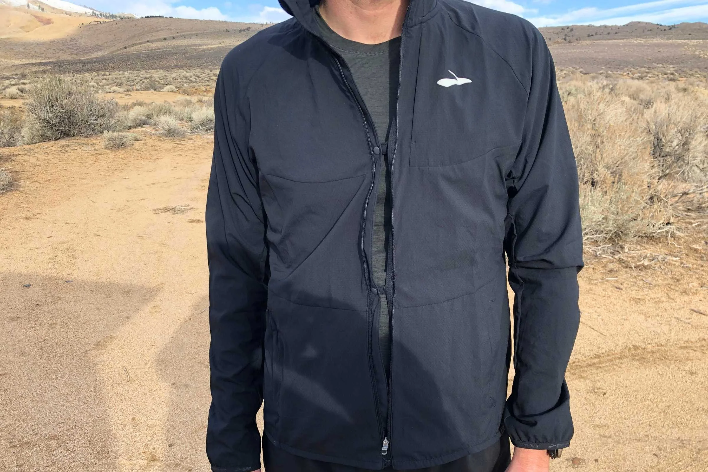   The Brooks Canopy has two button snaps that allow venting out the front without unzipping the jacket fully for it to flap around.   Photo by Sasha Hashemipour.  