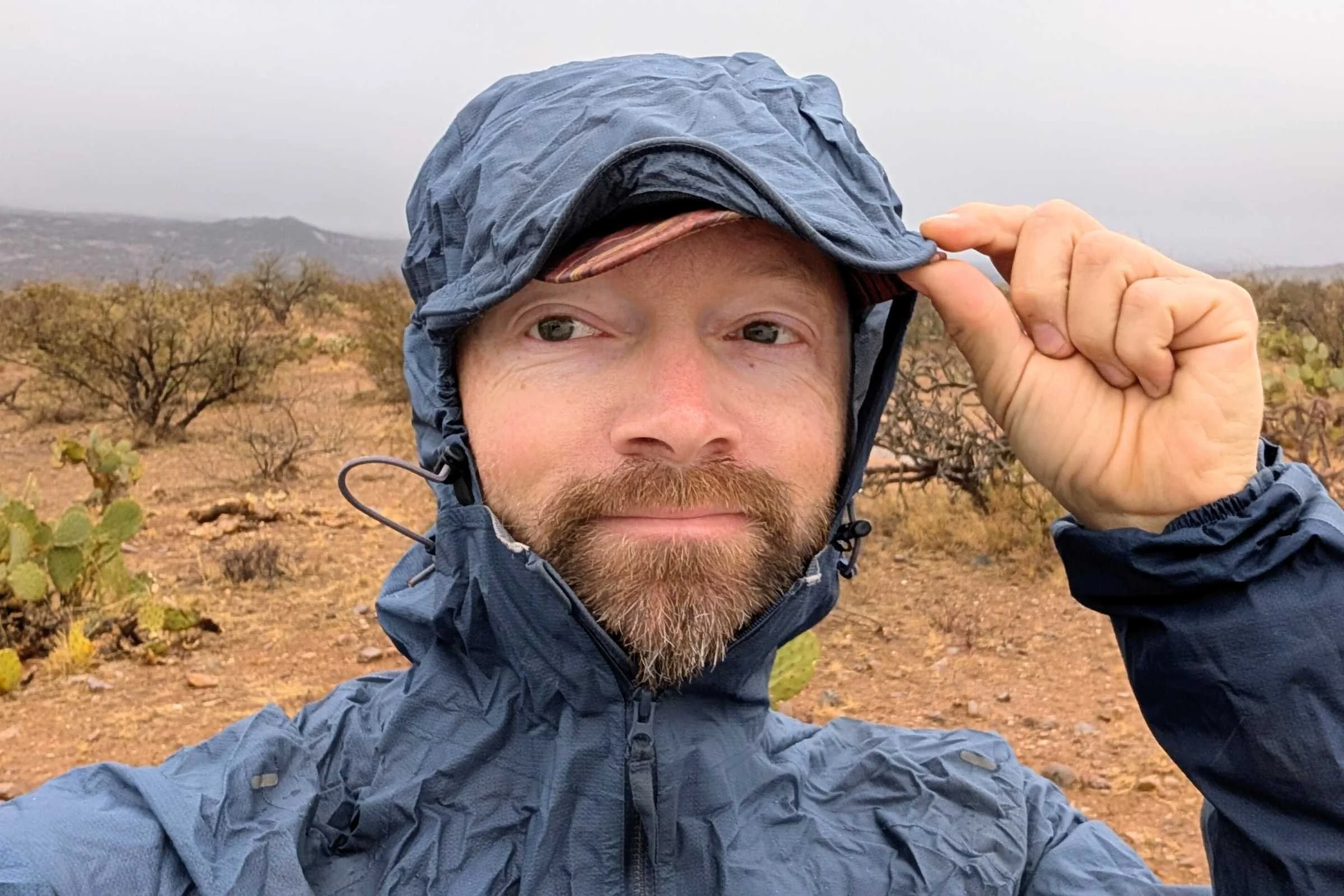   Close up of man’s head wearing Ultimate Direction Ultra with the hood up and cinched  