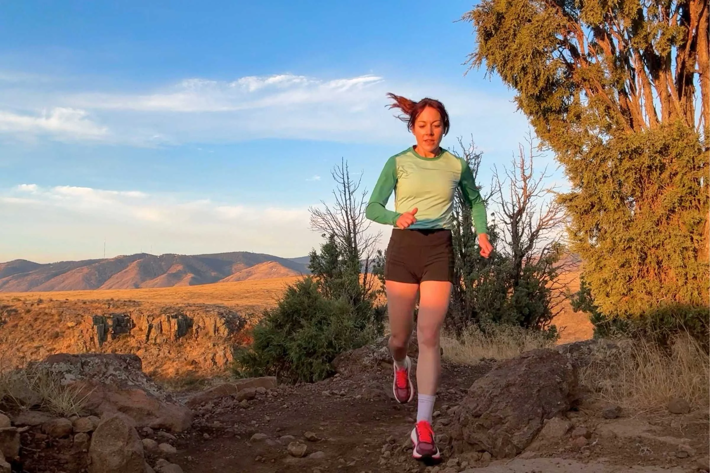 a awoman runs at sunset in the mountains 