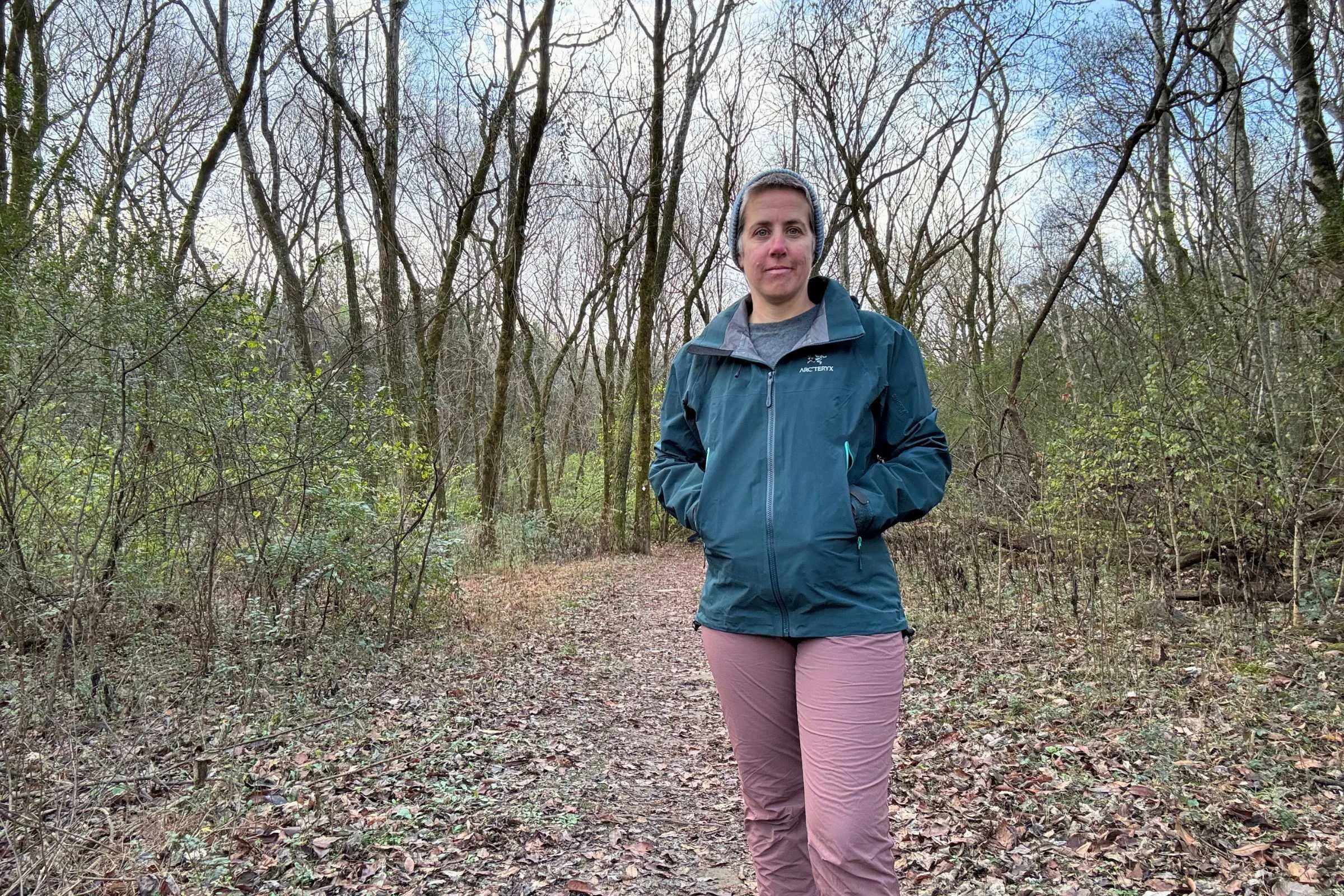  hiker wearing a blue Arc’teryx Beta AR jacket on trail 