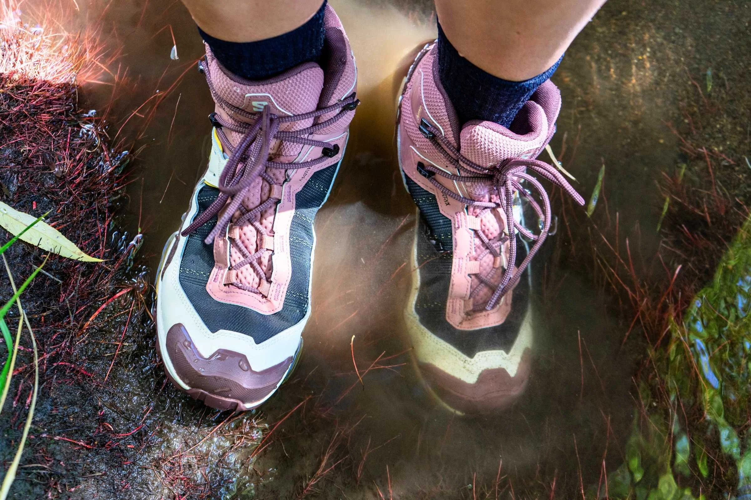   Top down view of Salomon X Ultra 5 GTX boots being tested for waterproofness in a stream  