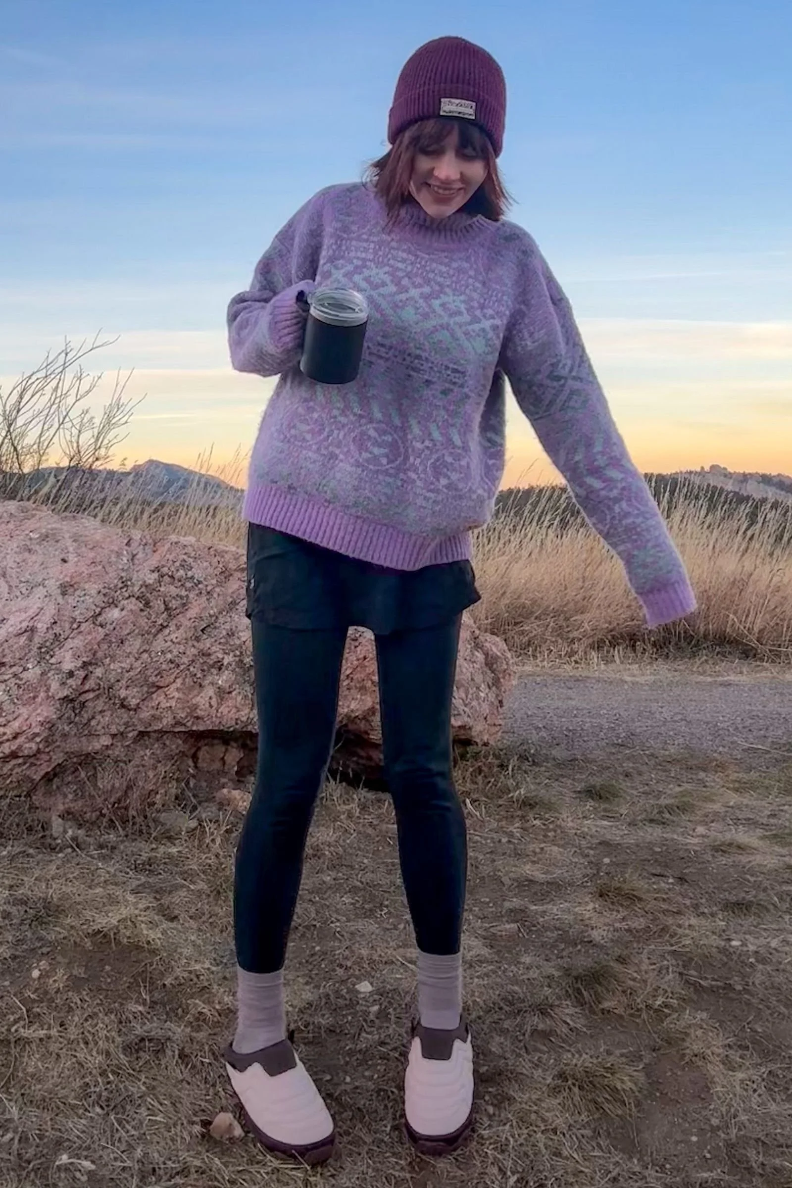   Woman wearing Teva ReEmber Terrain Slip-ons in camp holding a coffee mug  