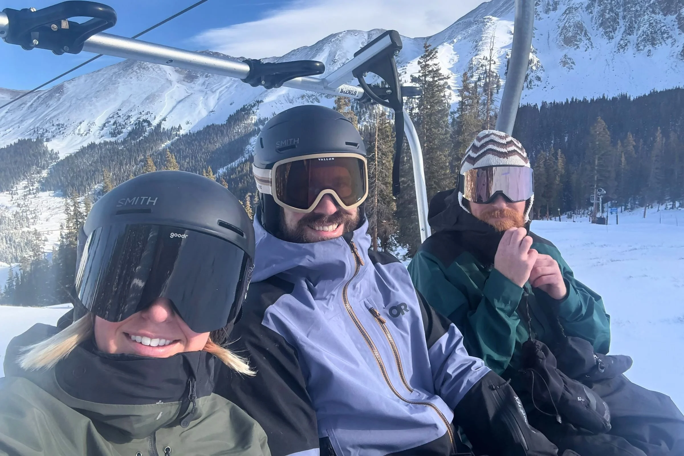   The author (left) skiing on a sunny day in the Goodr Snow G goggles  