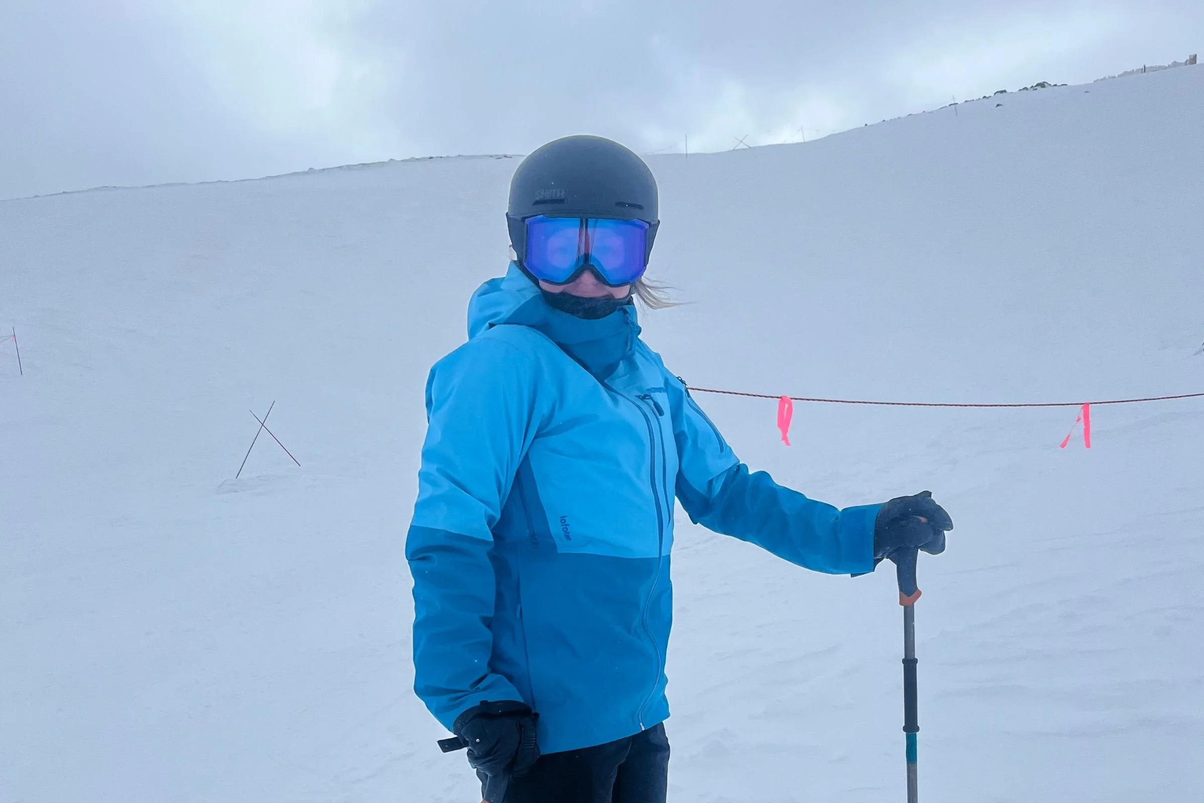   Skier standing on slope wearing Smith Squad MAG goggles  
