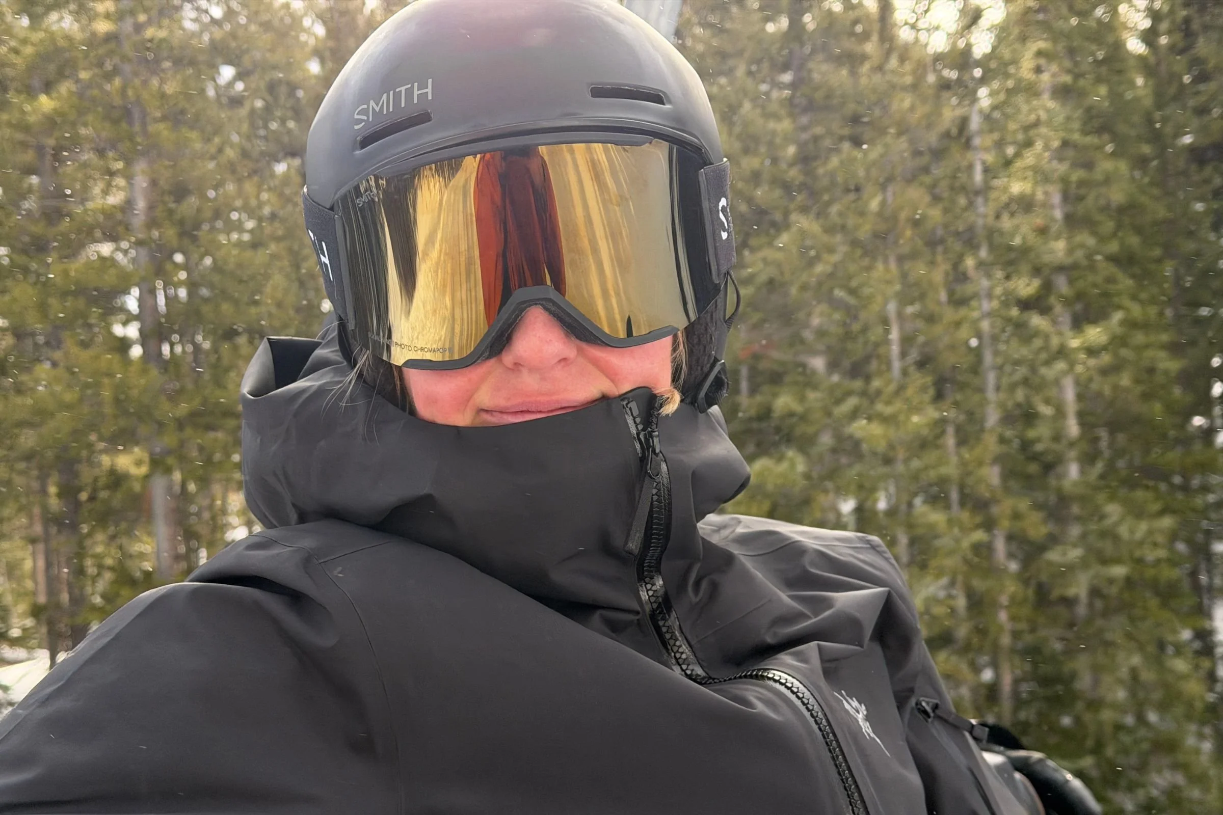   Close-up of skier wearing Smith Squad MAG goggles in trees  