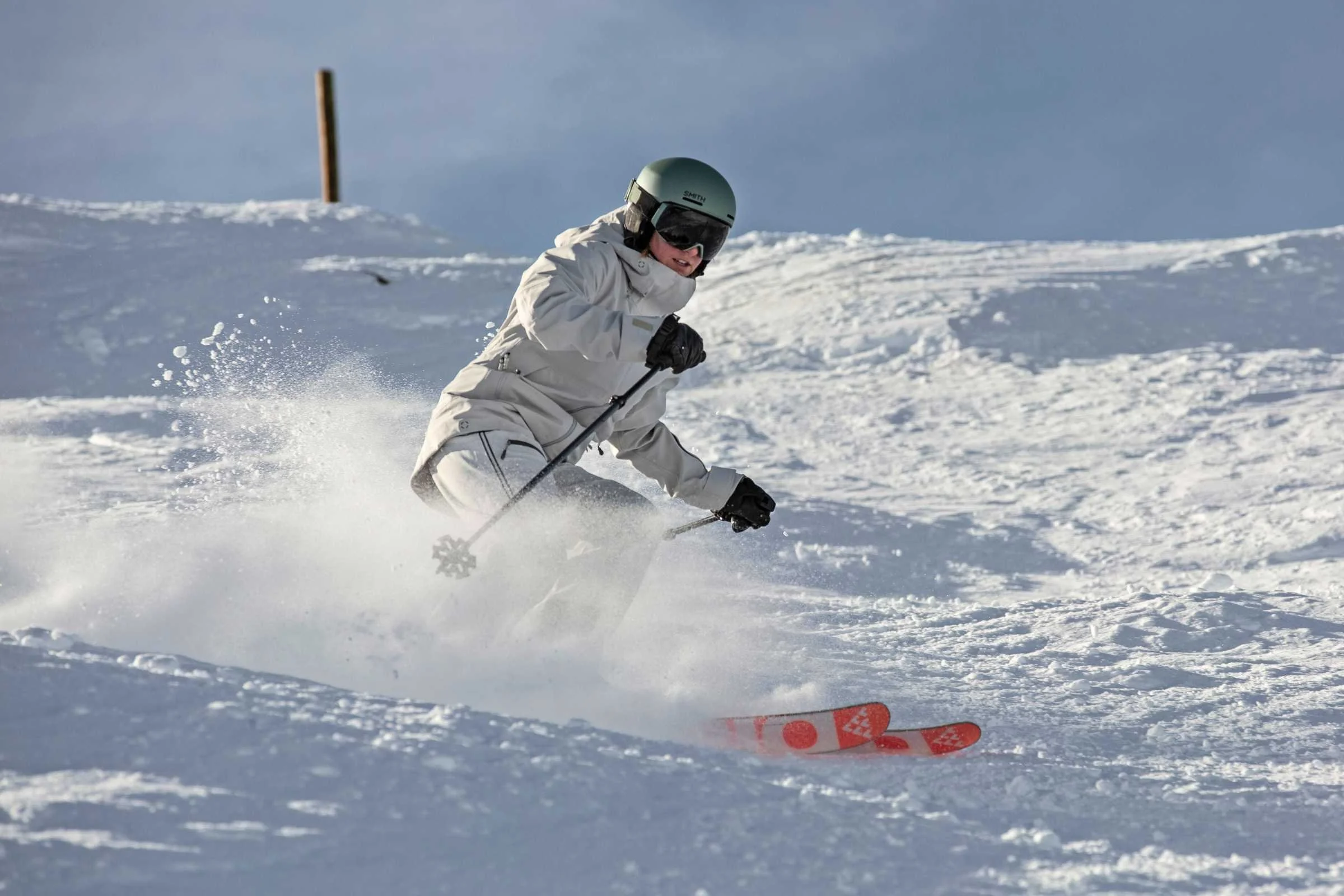   Skier carving in snow wearing Smith Method MIPS helmet  