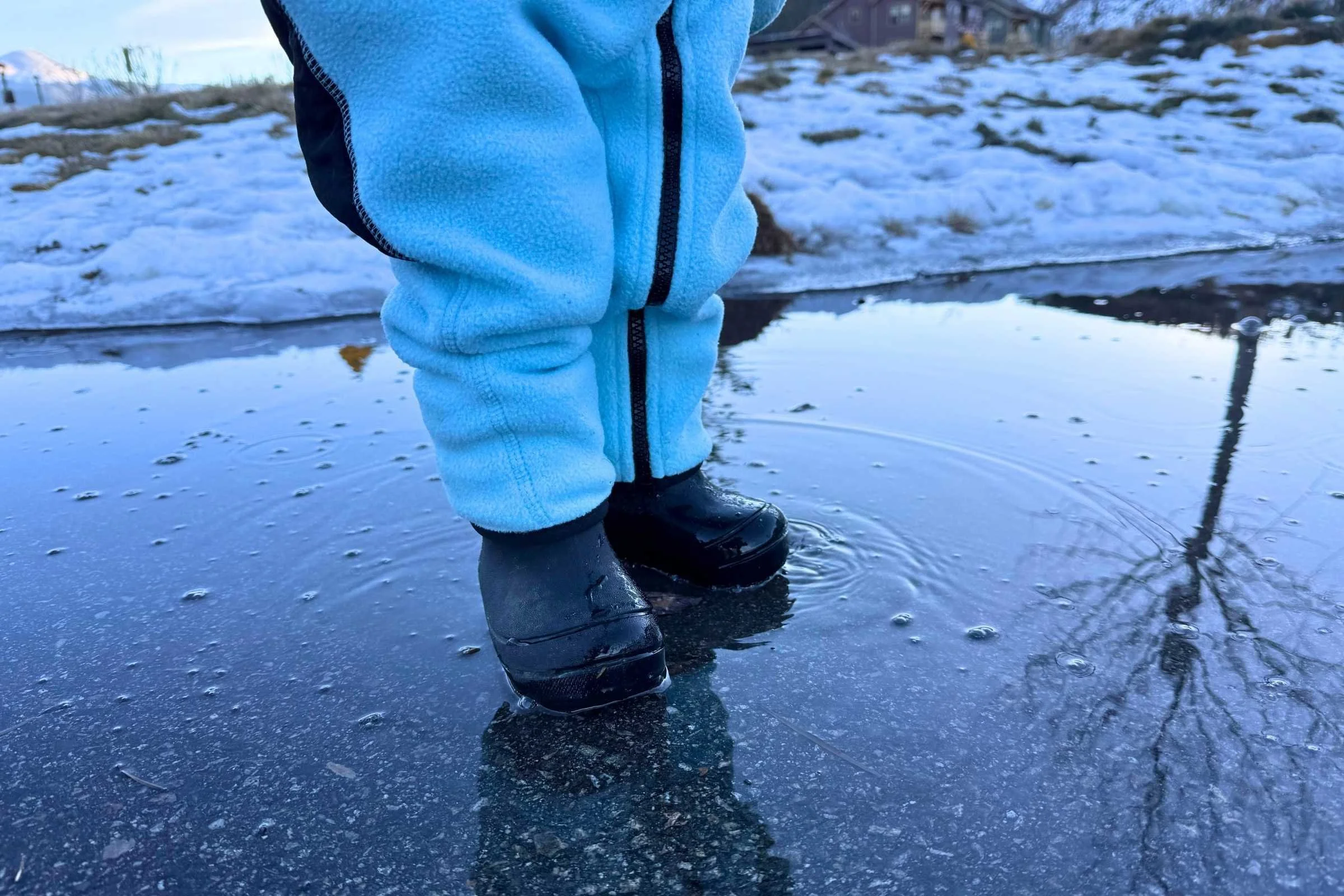   Our toddler tester happily splashing in an icy puddle with warm and dry feet in the Bogs Snow Shell boots.  
