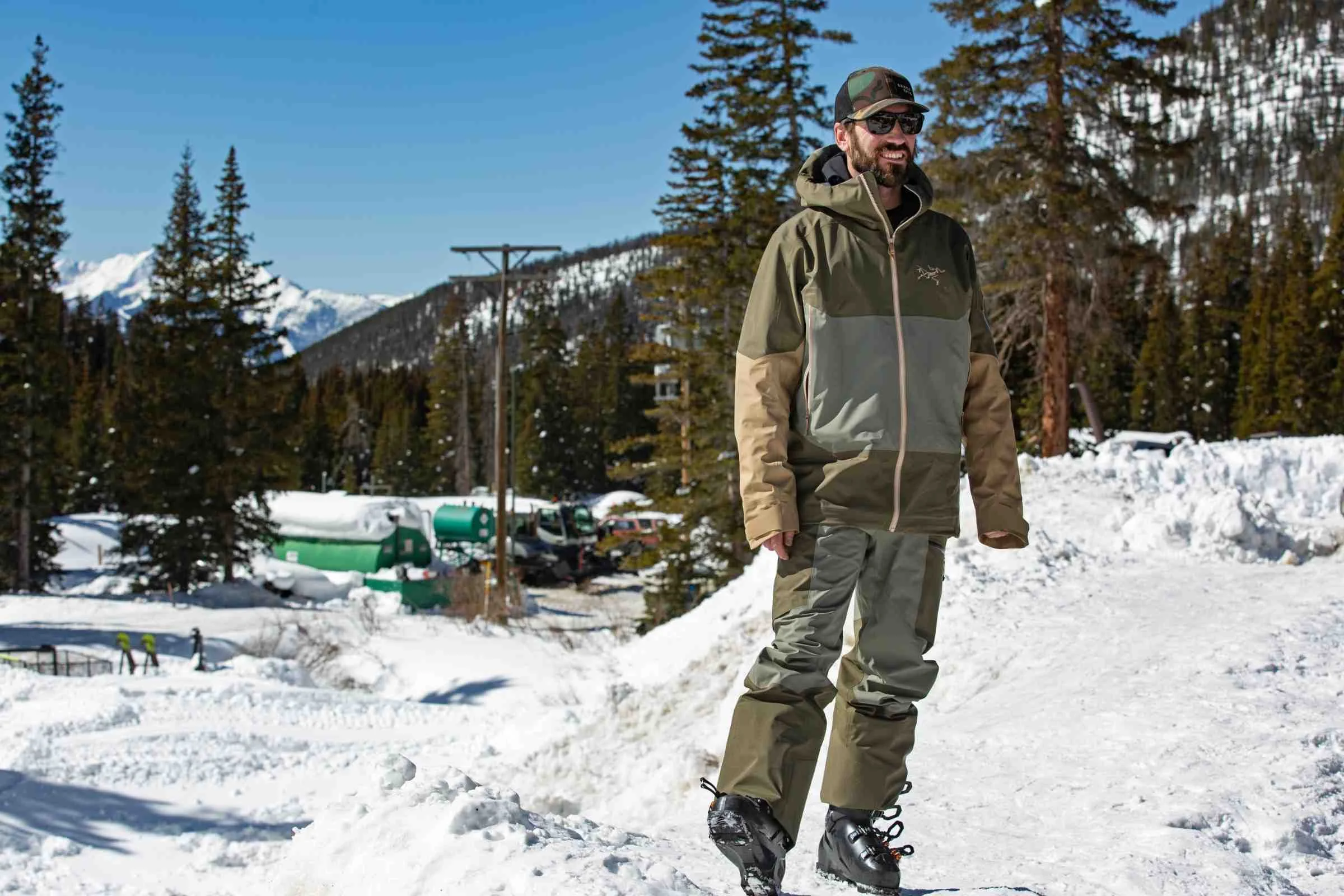   Man standing in snow wearing Arc'teryx Sabre ski jacket  