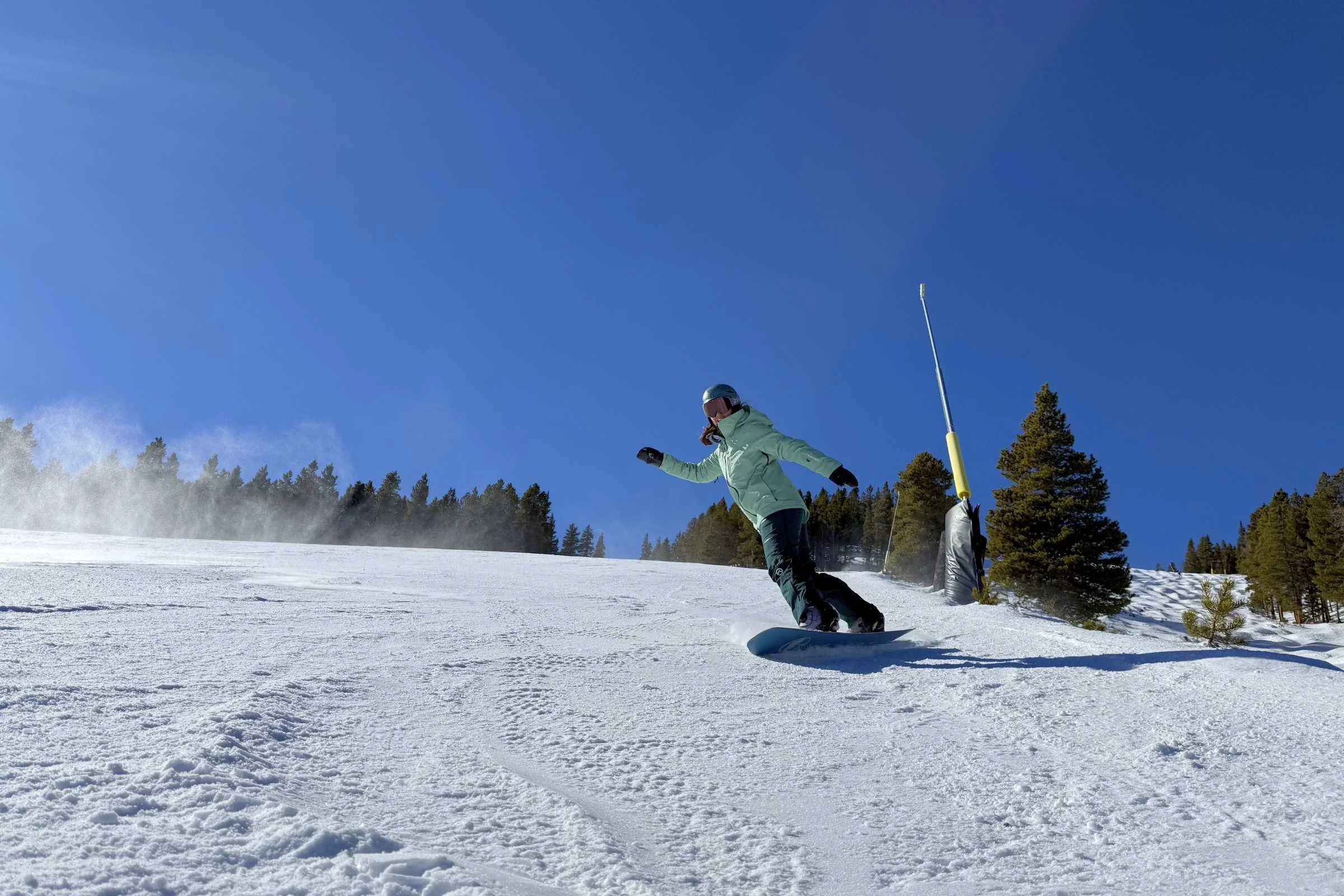   Snowboarder carving powder in the Burton Embark snowboard jacket.  