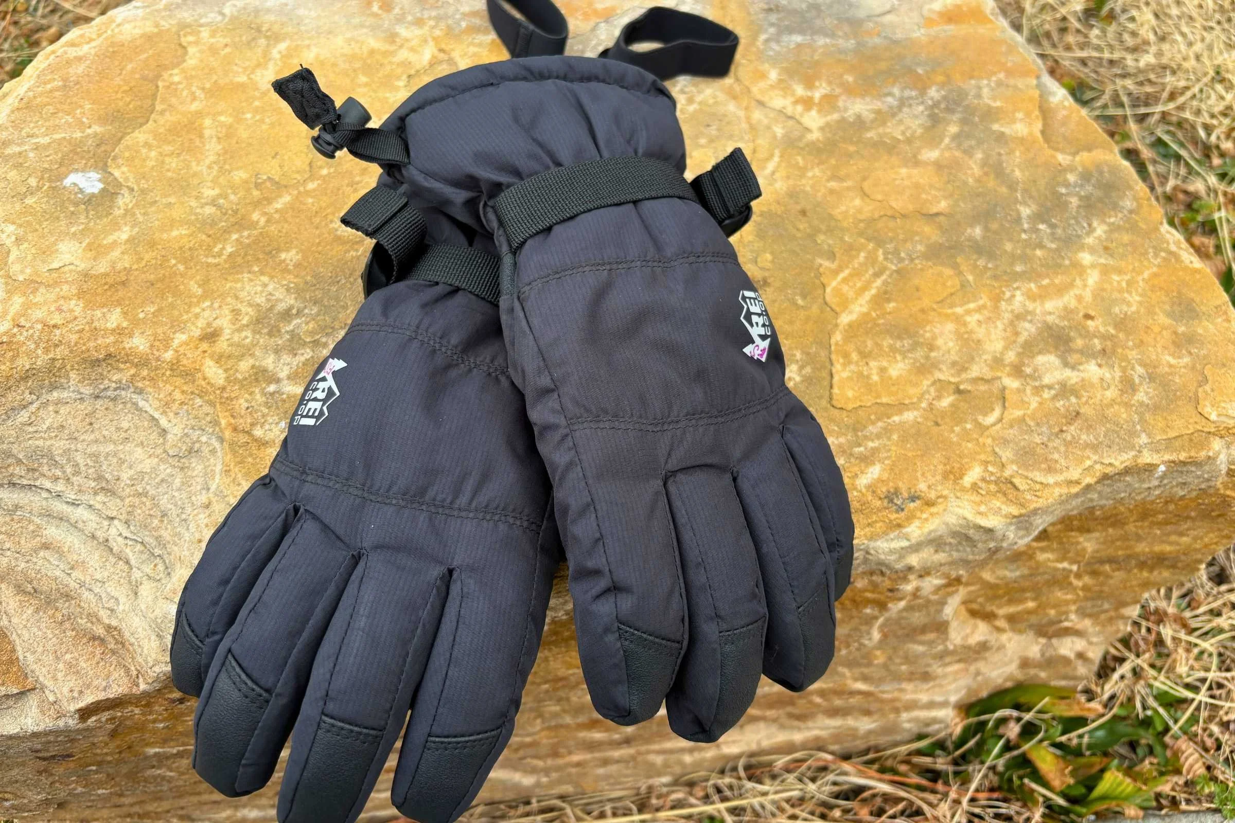   The tops of a pair of black REI Co-op Timber Mountain kids’ gloves  
