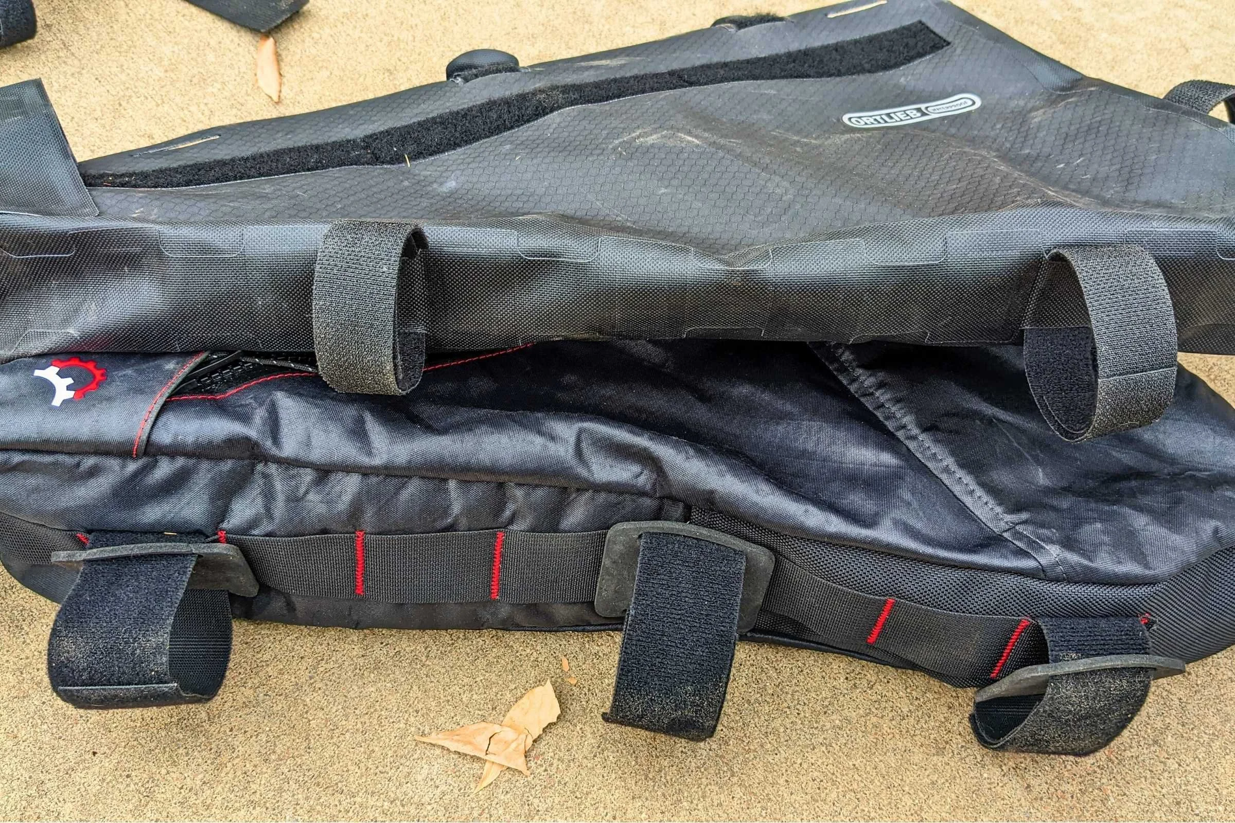   Comparing the Revelate bike bag (bottom) with the ORTLIEB Frame-Pack full frame bag (top).   Notice the different sizes of the three Velcro straps on the Revelate.  