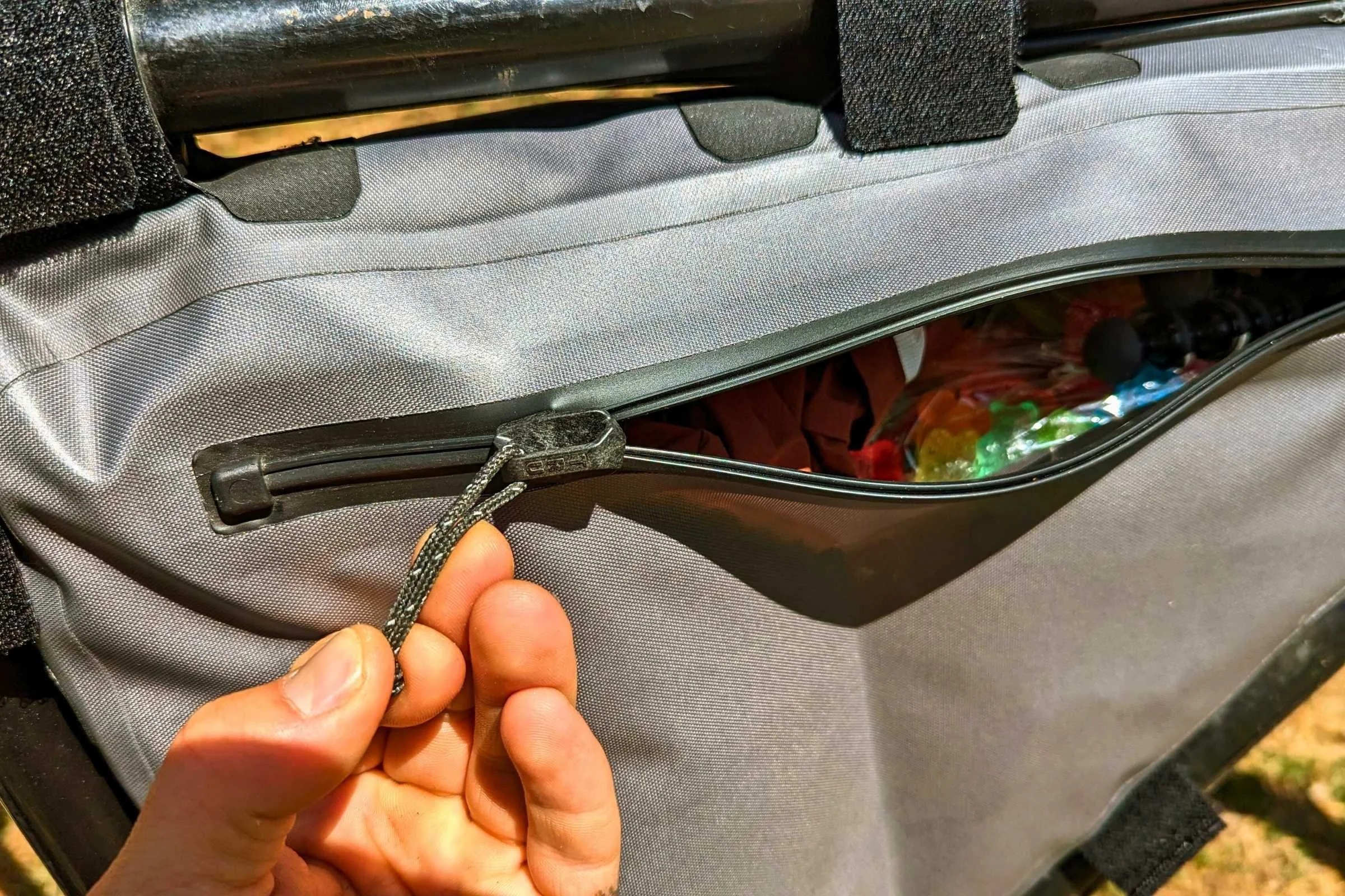   Close-up on the waterproof zipper on the REI Co-op frame bag. It keeps water out very well but can be difficult to open and close.  