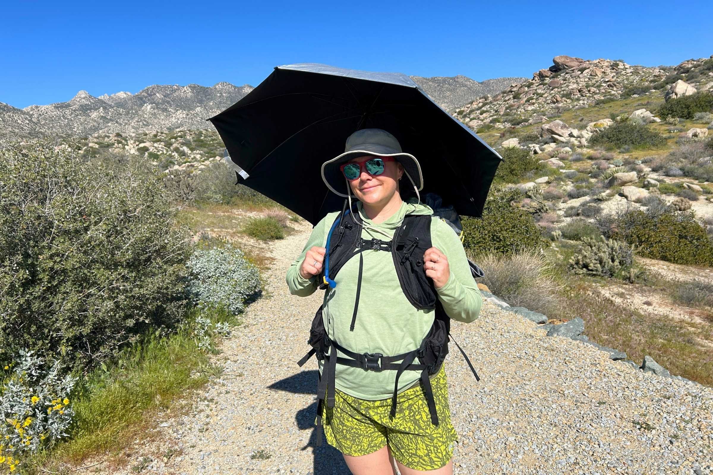   Treeline Review writer Katie Hawkes with the SMD Silver Carbon hiking umbrella. This hiking umbrella held up to high winds on this ridge in Anza Borrego Desert State Park.  