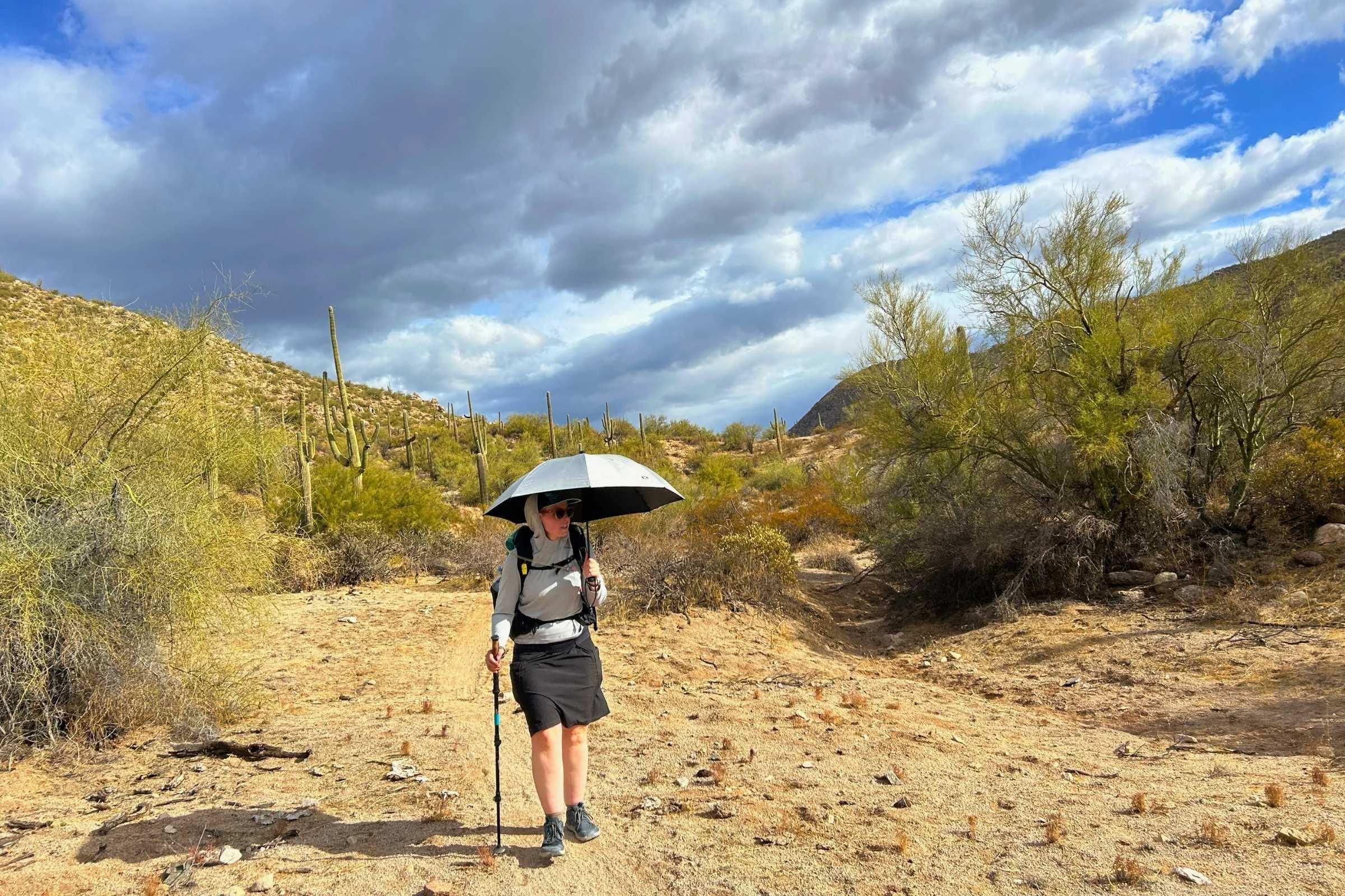  Hiker on trail with the Lightrek Hiking Umbrella 