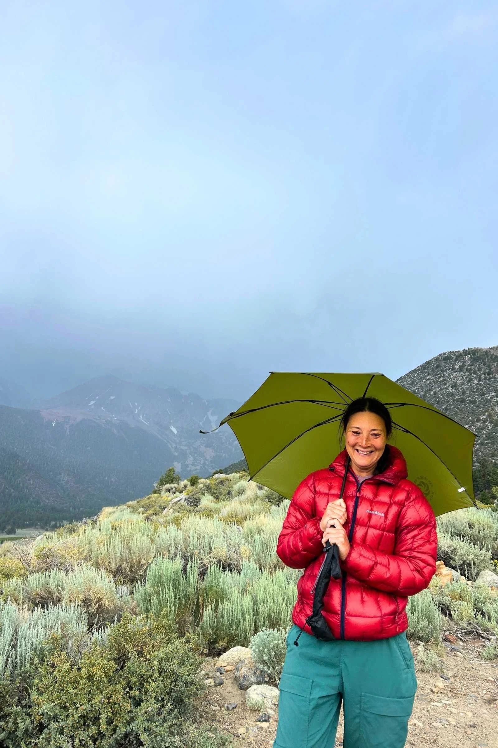   Treeline Review editor Liz Thomas in the rain in the Eastern Sierra with the SMD Rainwalker umbrella.  