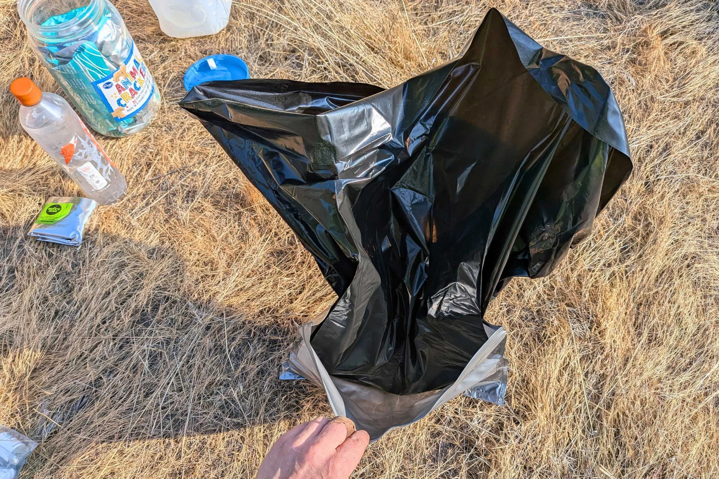   Start to use the Camco toilet waste bag by opening the inner bag attached to the outer disposal bag.  