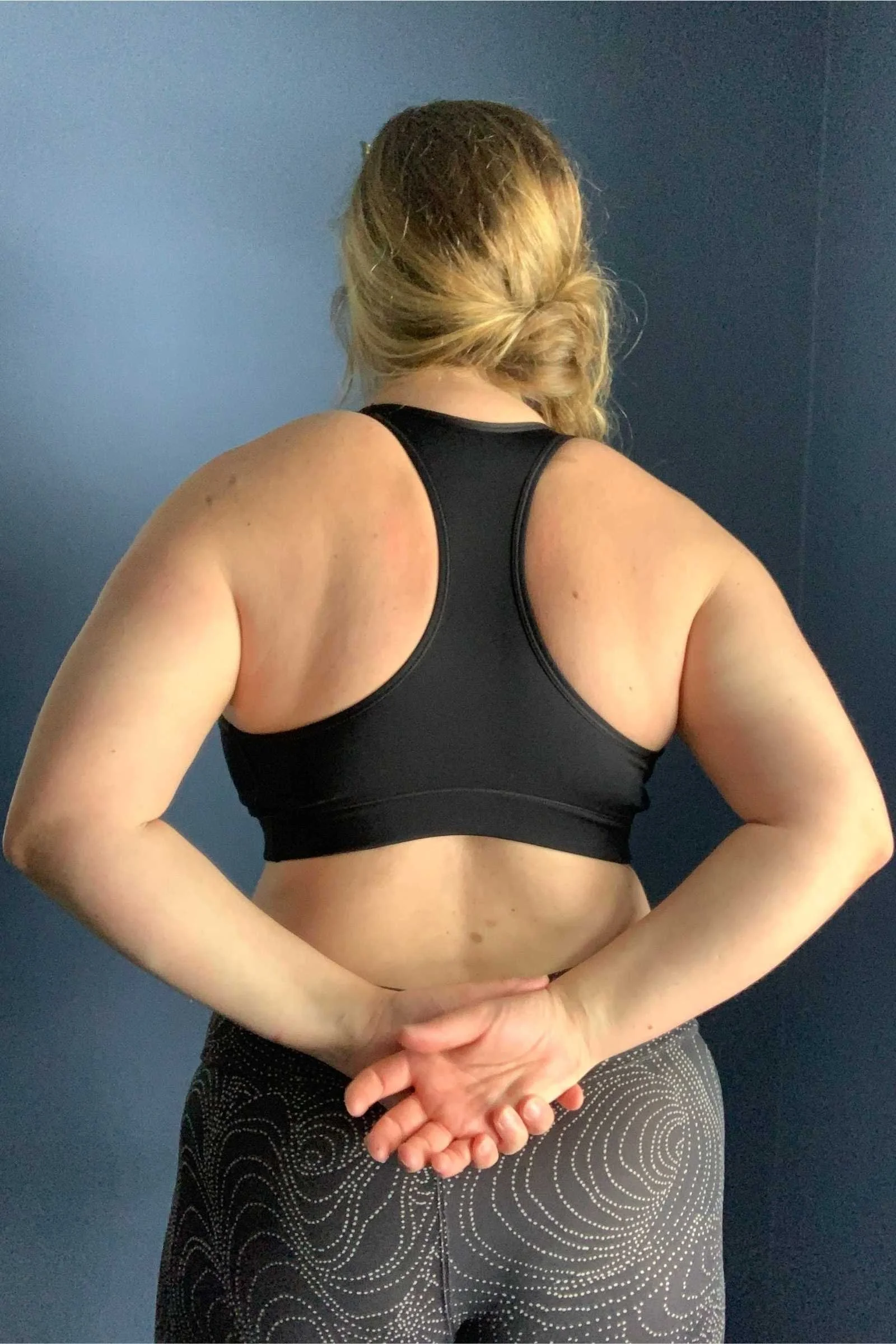   Back view of the Nike Swoosh sports bra showing racerback fit and band coverage.  