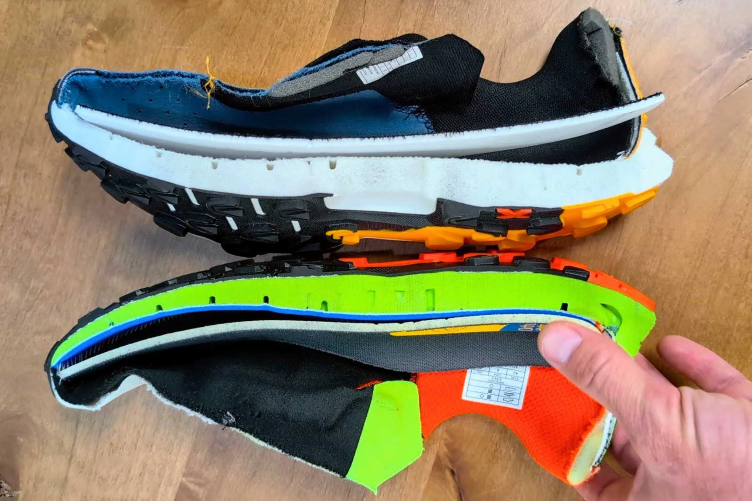   Side profile comparison of the La Sportiva Prodigio 2 trail running shoe next to another shoe, showing midsole thickness and stack height.  