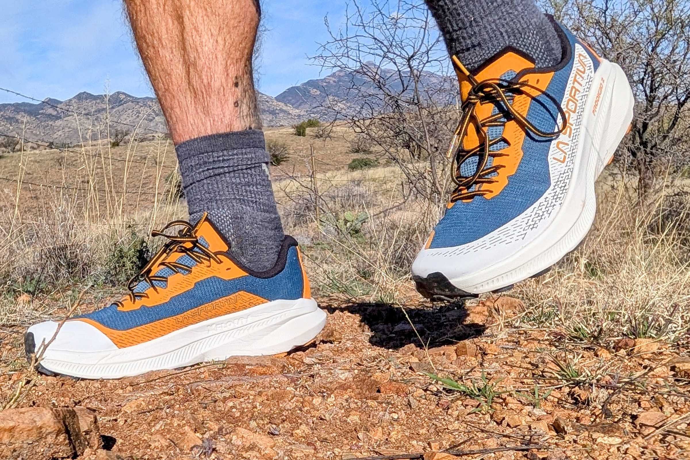   Side view of the La Sportiva Prodigio 2 trail running shoe worn on rocky trail terrain.  