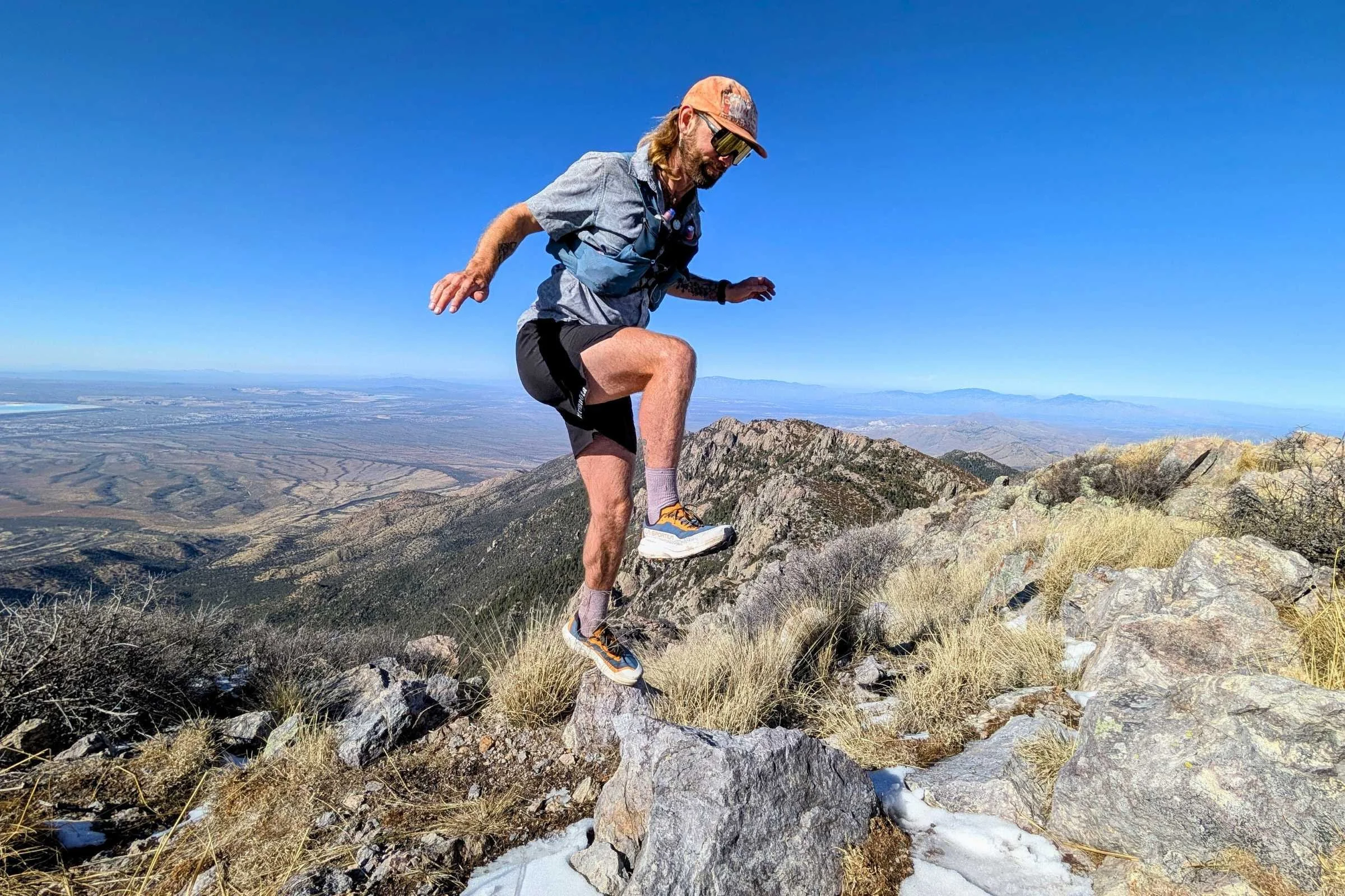   Runner scrambling over rocks while wearing the La Sportiva Prodigio 2 trail running shoes.  