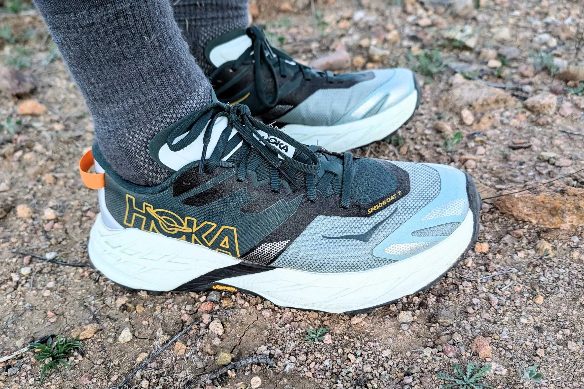   Close-up side view of the HOKA Speedgoat 7 trail running shoes showing the upper and cushioned midsole.  