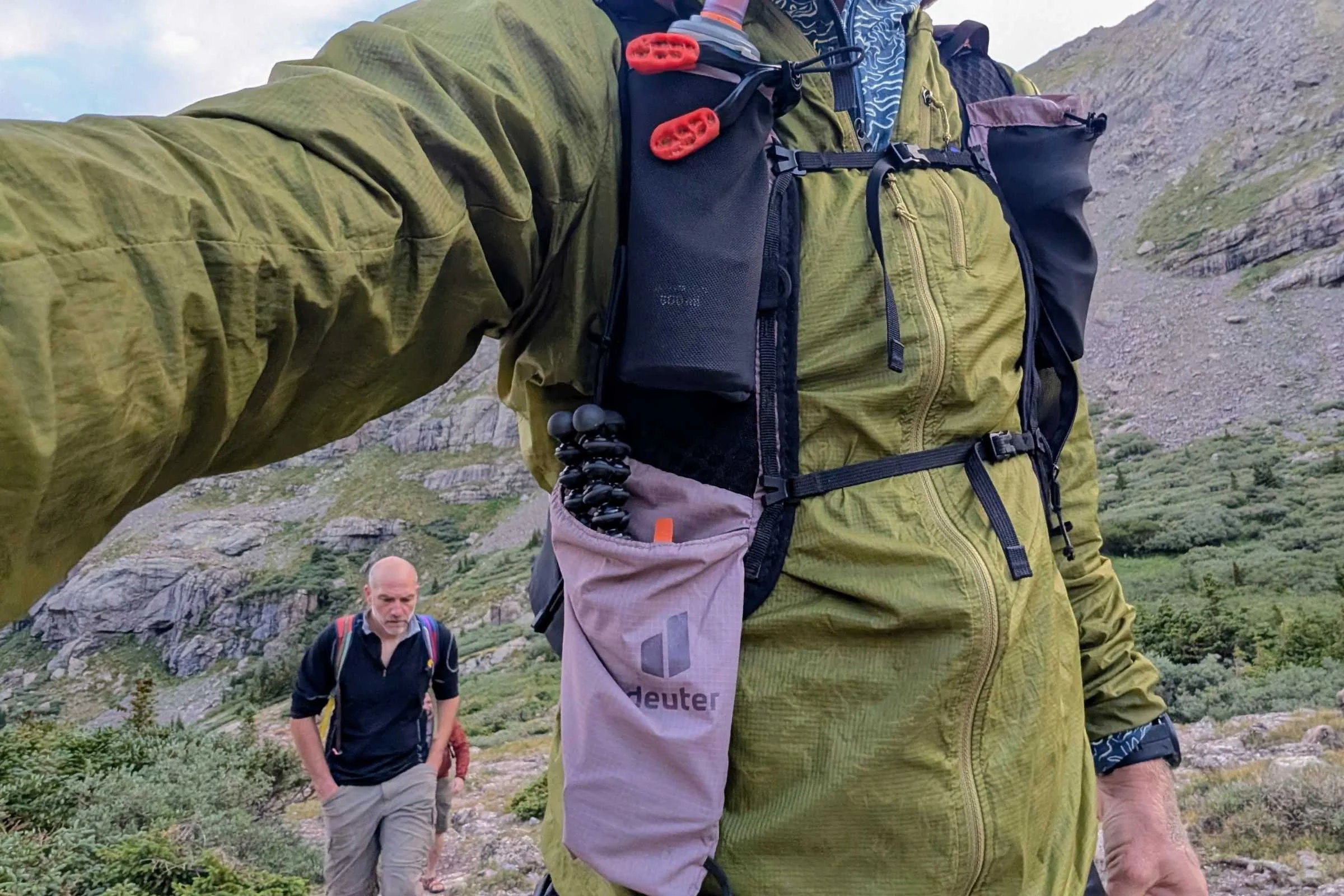   Close-up of the Deuter Ascender 13 running pack front harness showing pocket layout and chest straps in use.  