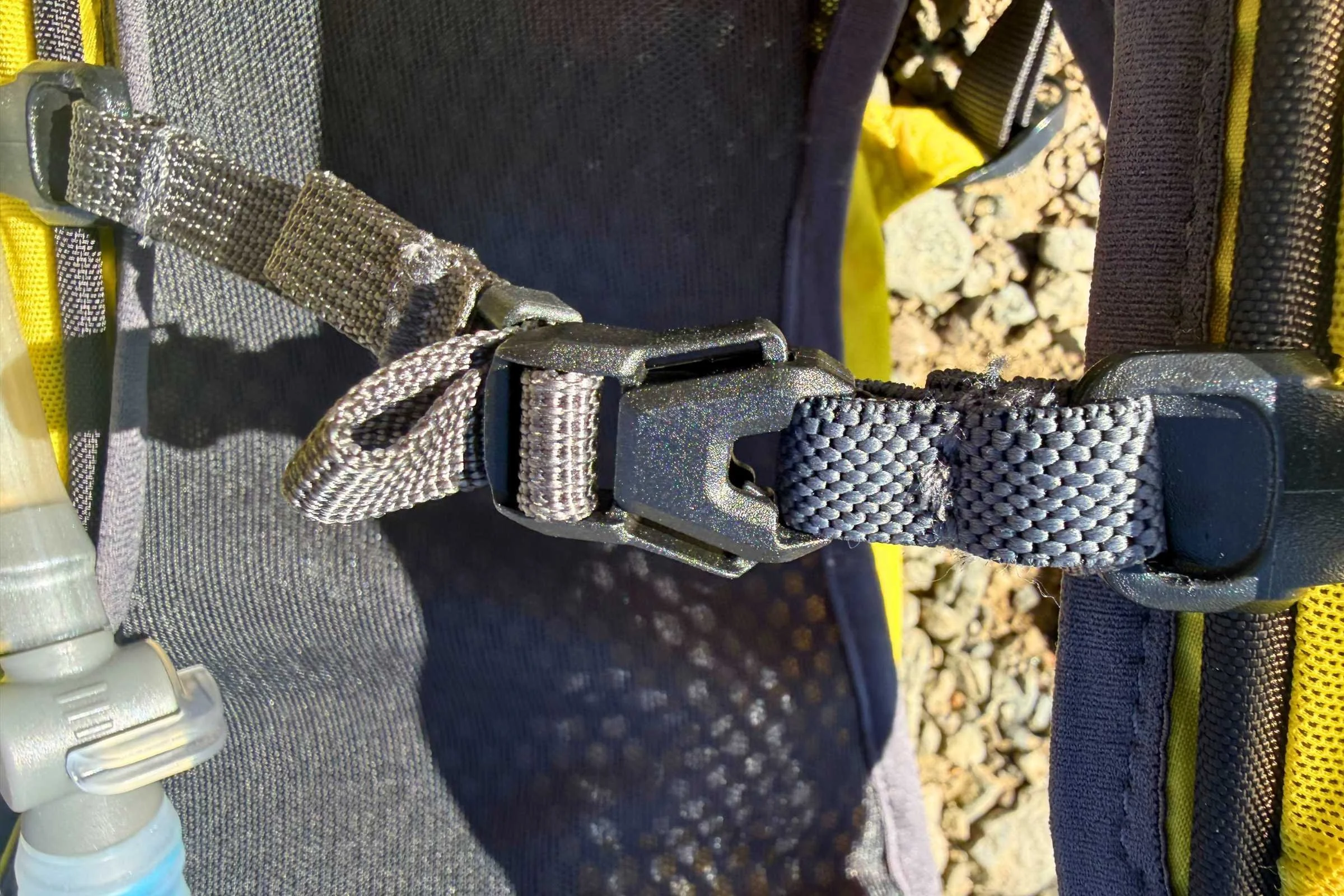   Close-up of the REI Co-op Swiftland 5 Hydration Vest chest strap and buckle system.  