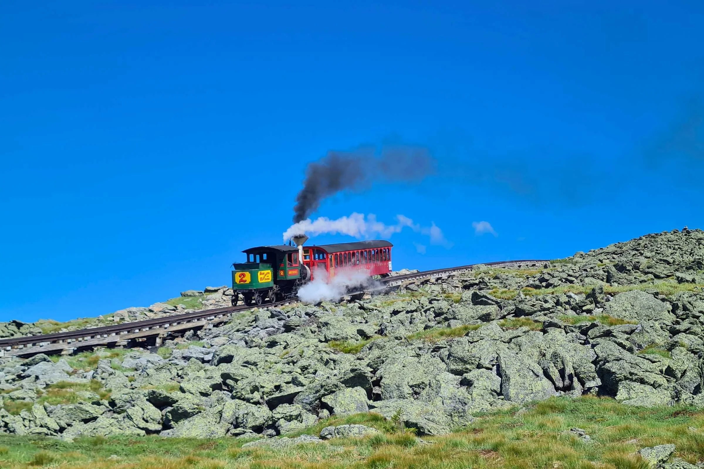   Cog railway train climbing rocky slopes in the Presidential Range of New Hampshire  