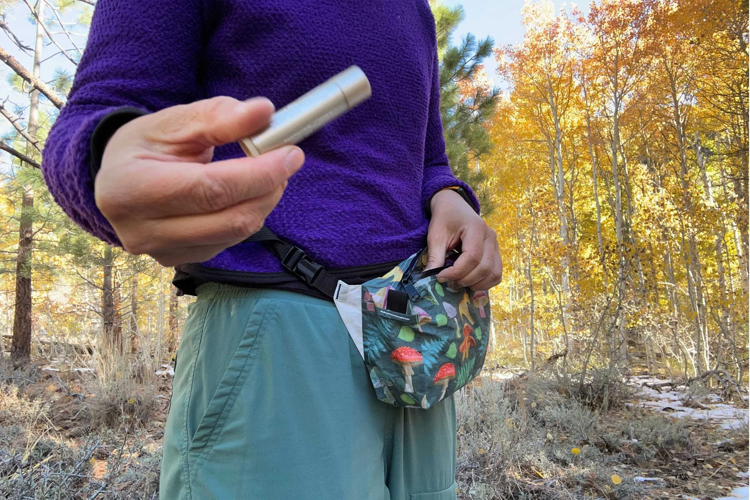  Close-up of Blistex Five Star Lip Protection SPF 30 carried in hiking waist pack during trail testing  