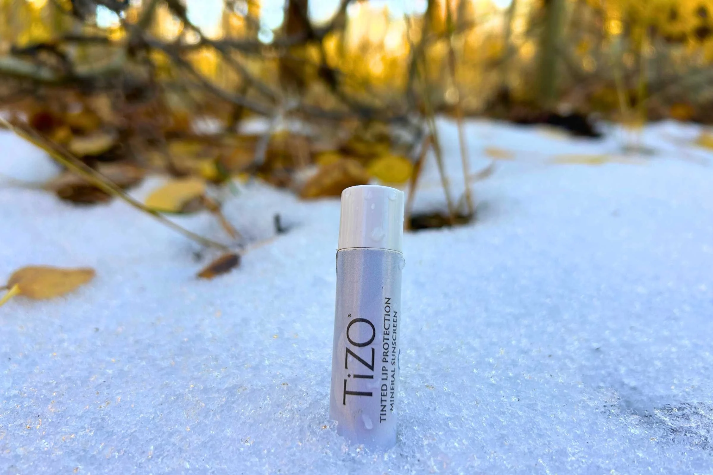   Tizo Lip Protection SPF 45 lip balm standing upright in snow during winter testing  