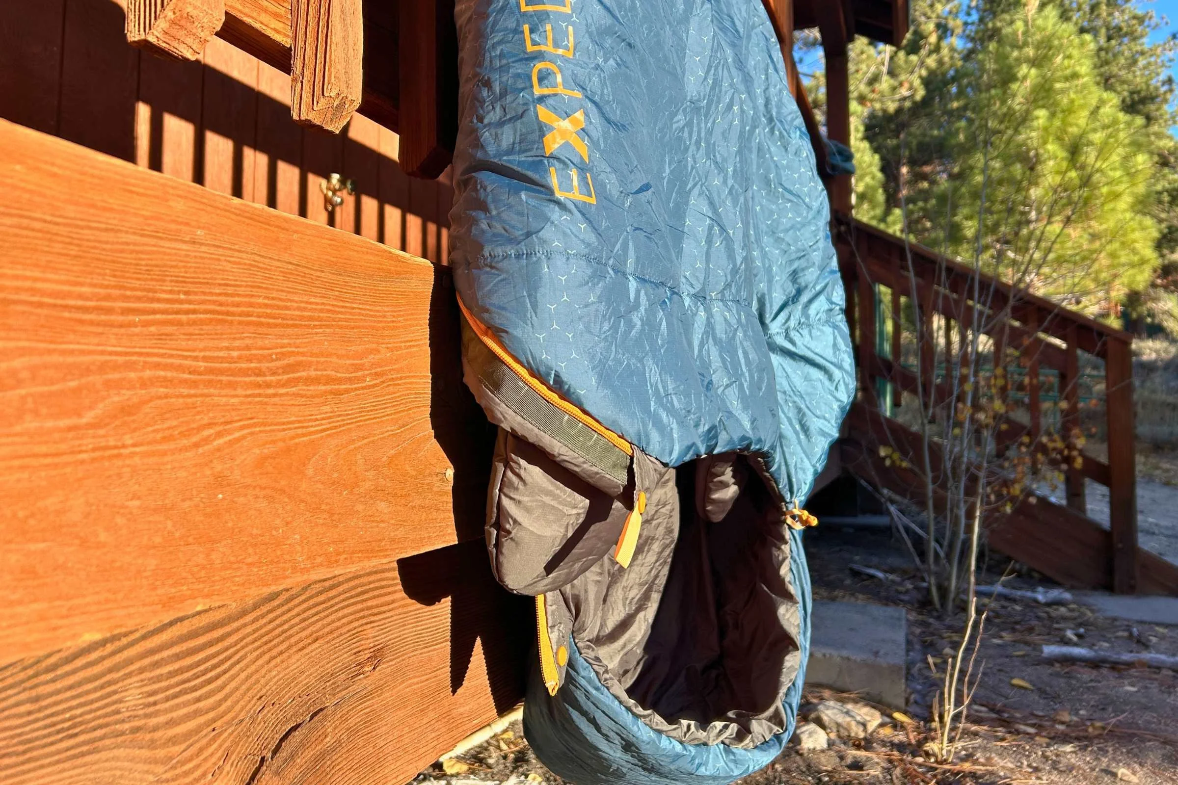   Exped DeepSleep sleeping bag hanging outdoors to air out at campsite cabin  