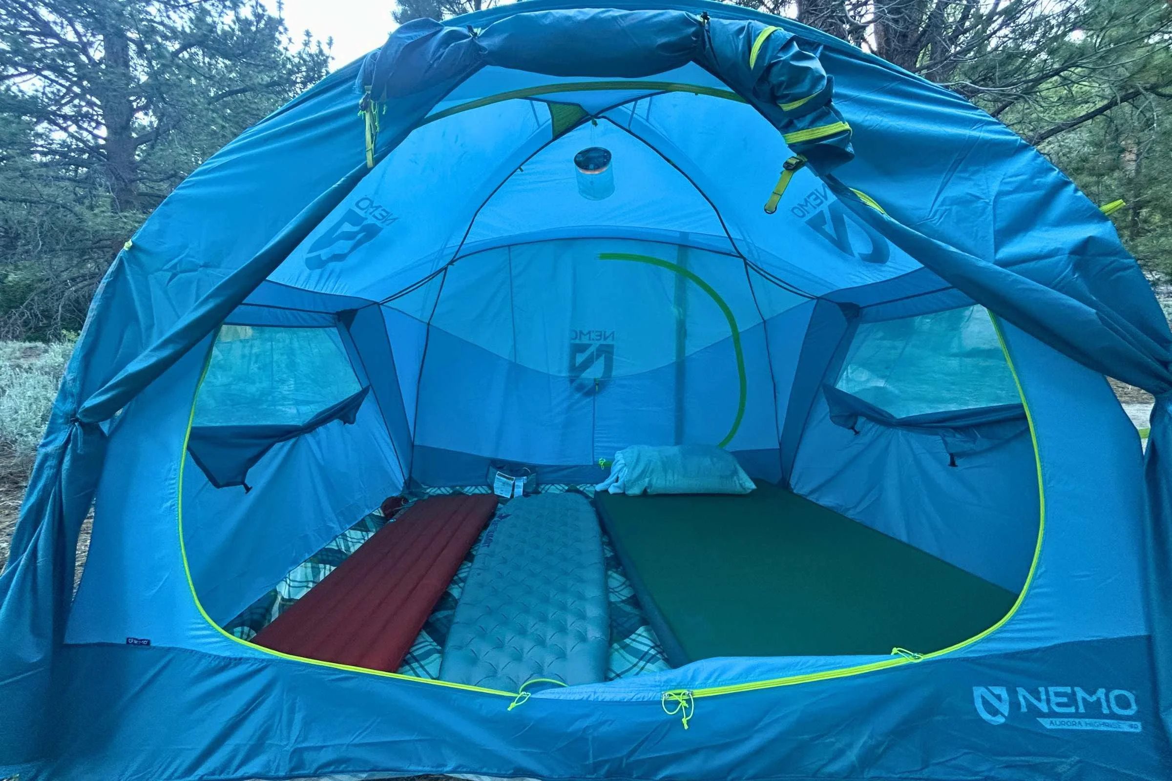   Inside the NEMO Aurora Highrise tent with sleeping pads set up for family camping  