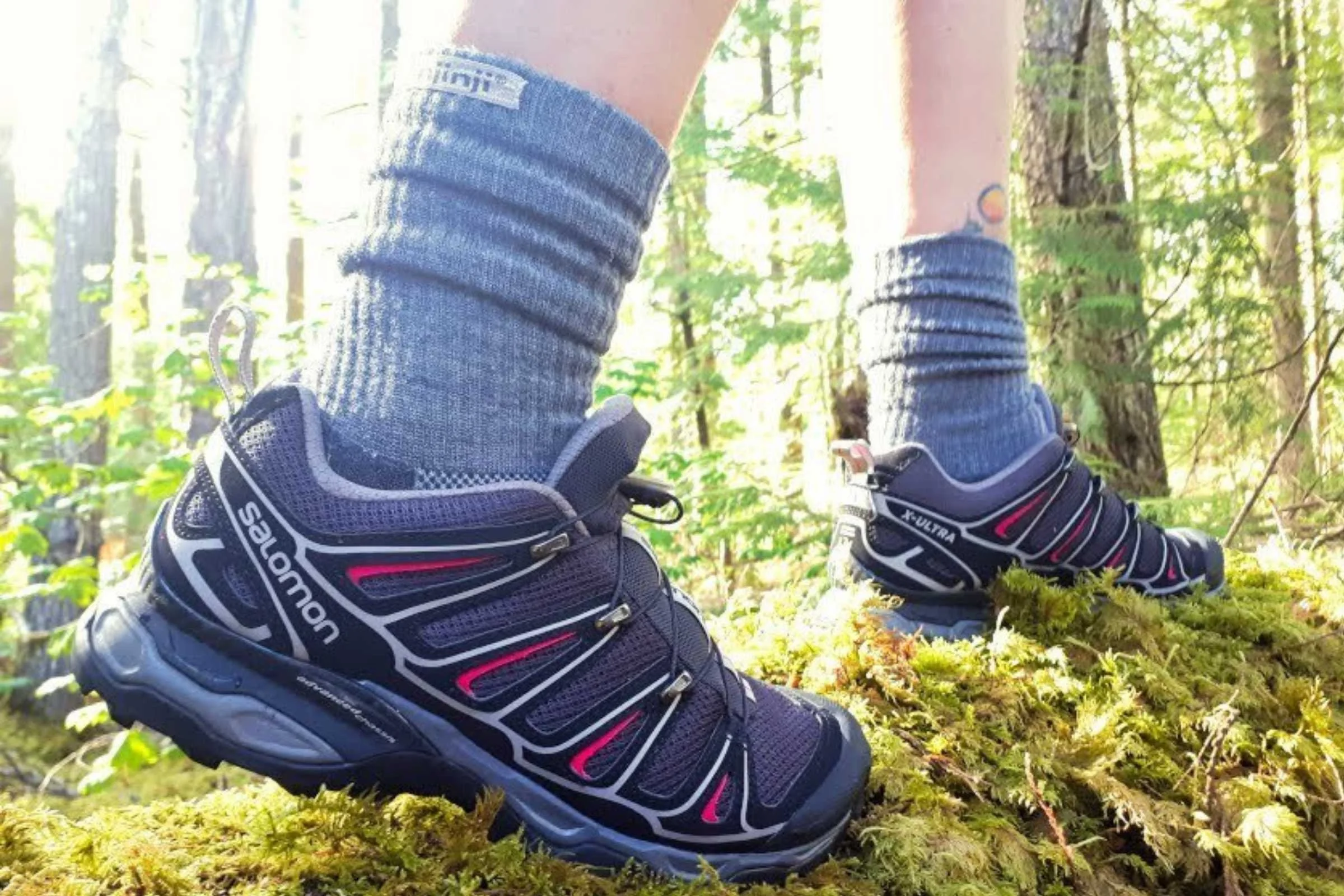   Close-up of Injinji Trail Midweight toe socks worn with light hiker shoes on mossy forest trail  
