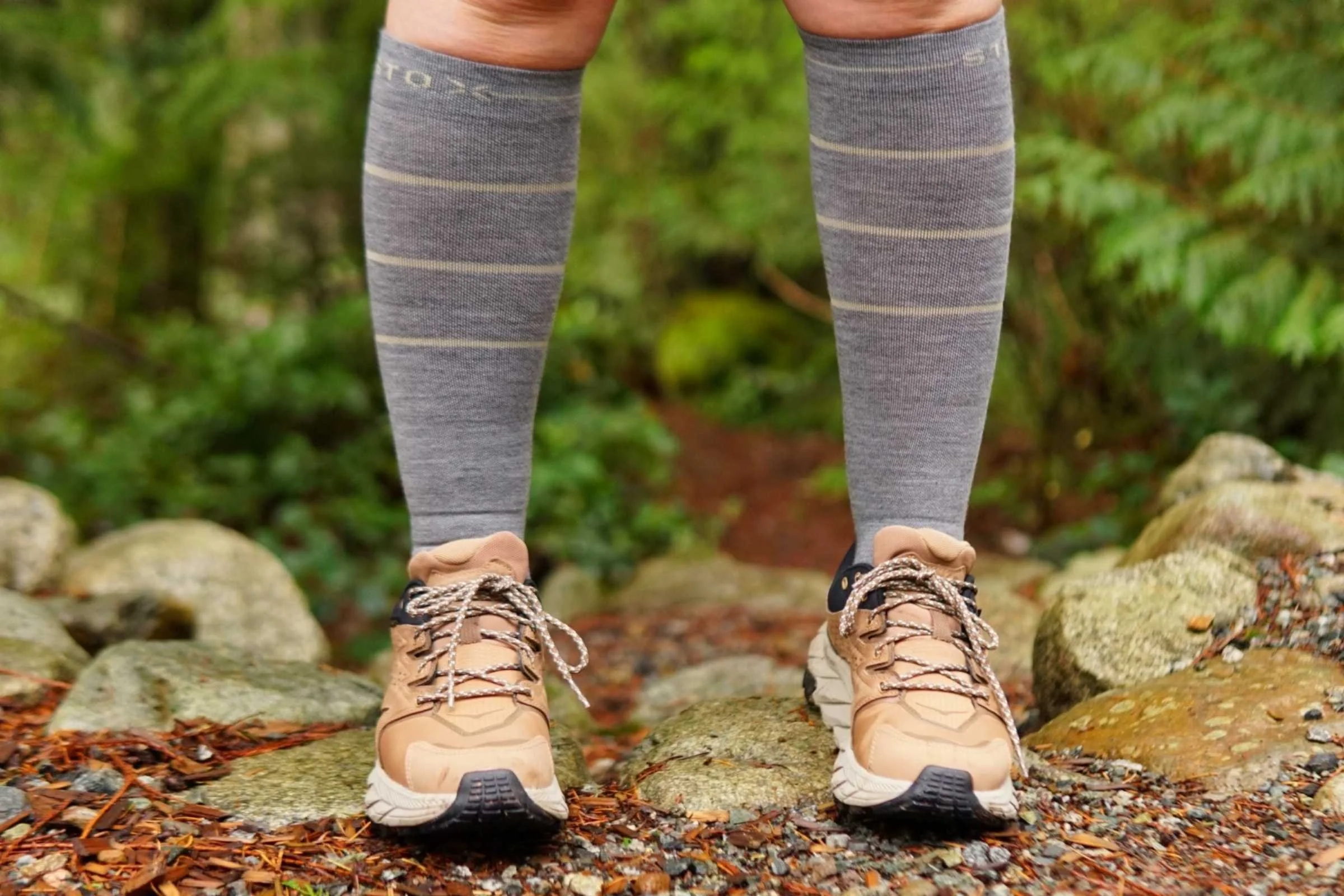   A front view of our tester wearing the Stox Energy Outdoor Socks with trail runners on a trail  
