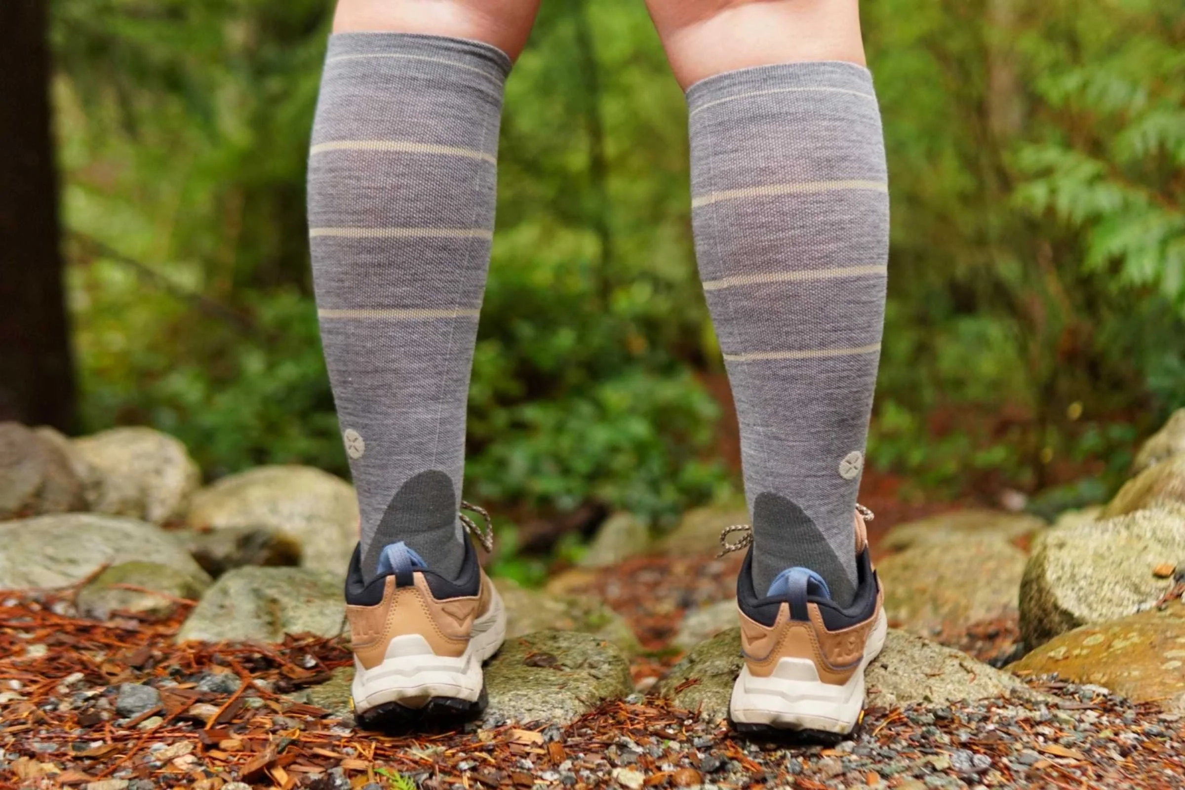   A back view of our tester wearing the Stox Energy Outdoor Socks with trail runners on a trail  