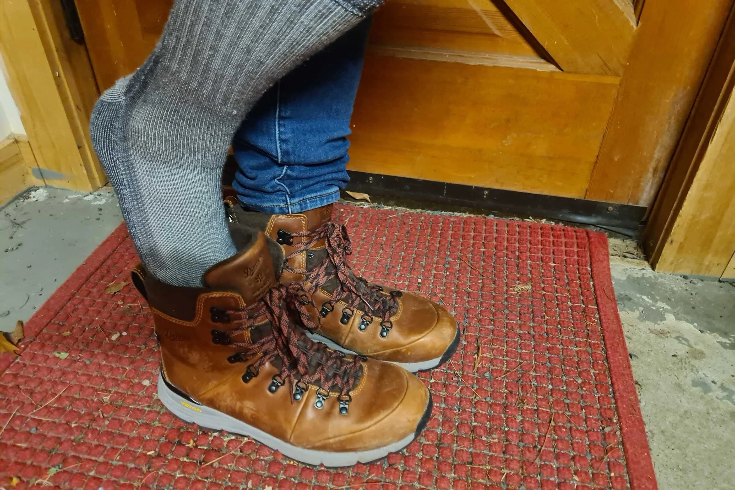   Smartwool Hike Classic Full Cushion sock clad foot slipping into a hiking boot  