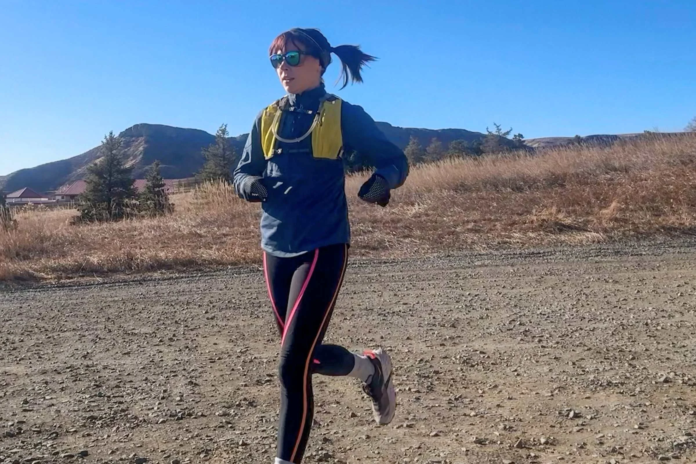   Woman wearing Knockaround Premiums Sport Polarized Sunglasses while running on dirt trail  