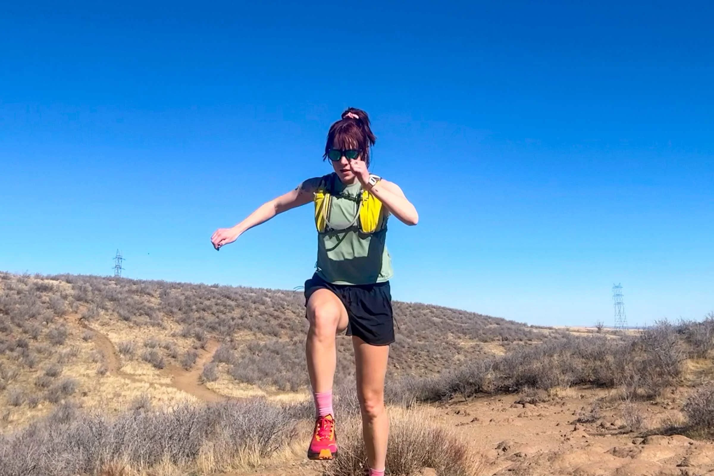   Runner doing warm ups on a desert trail wearing the Knockaround Premiums Sport Polarized Sunglasses  