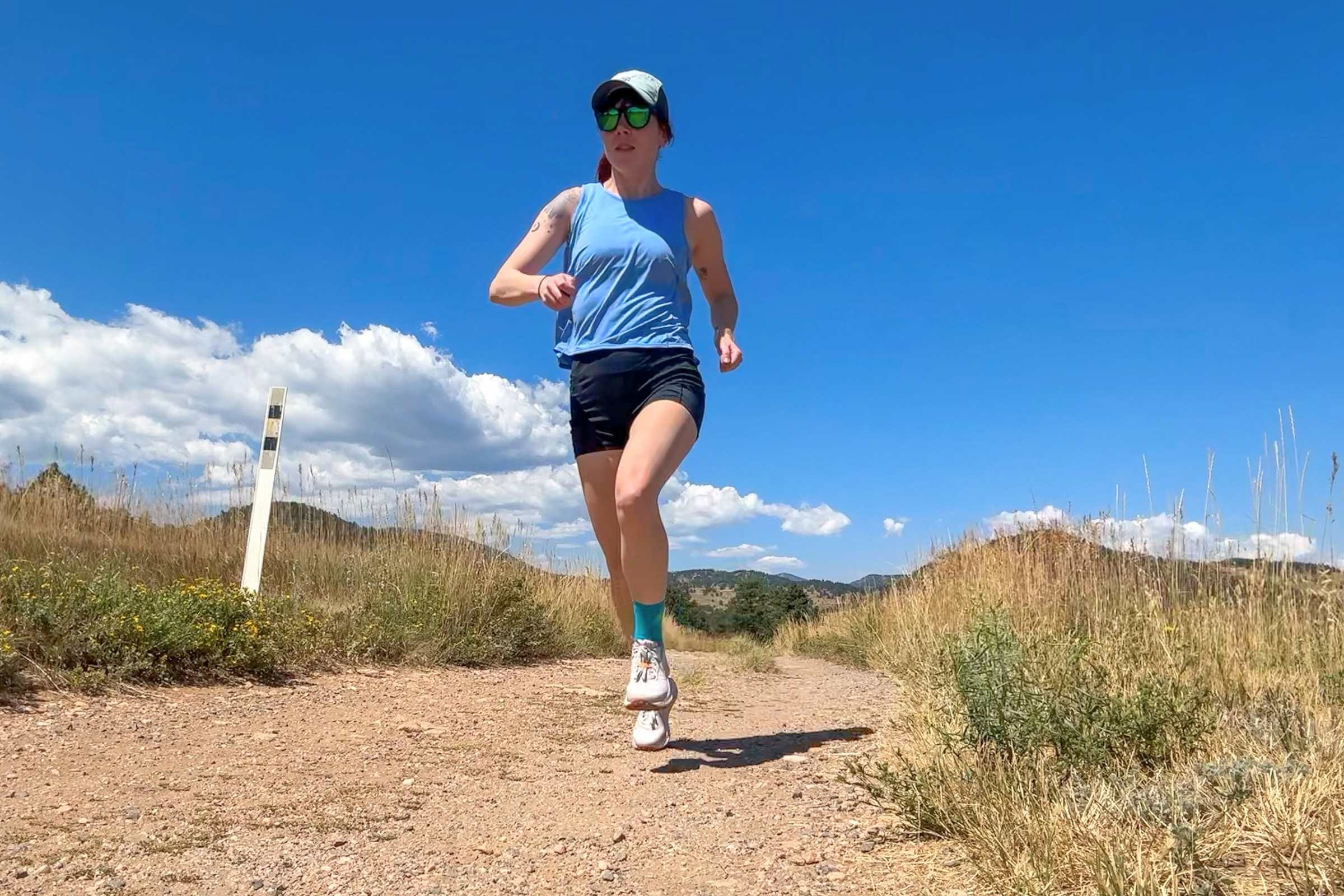   Front view of runner wearing Knockaround Premiums Sport Polarized Sunglasses on dirt path  