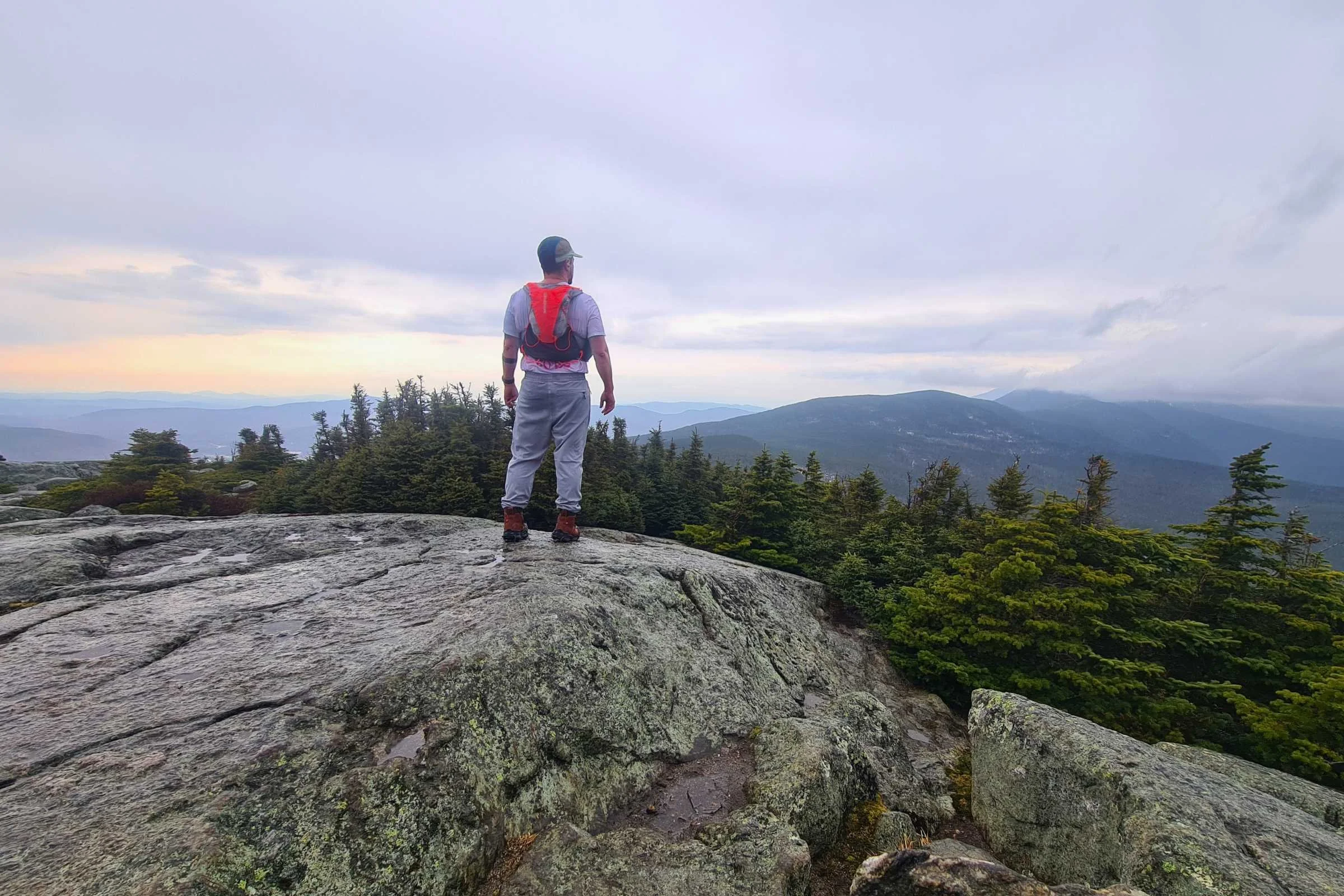   Runner wearing Salomon Adv Skin 12 hydration vest on overlook  