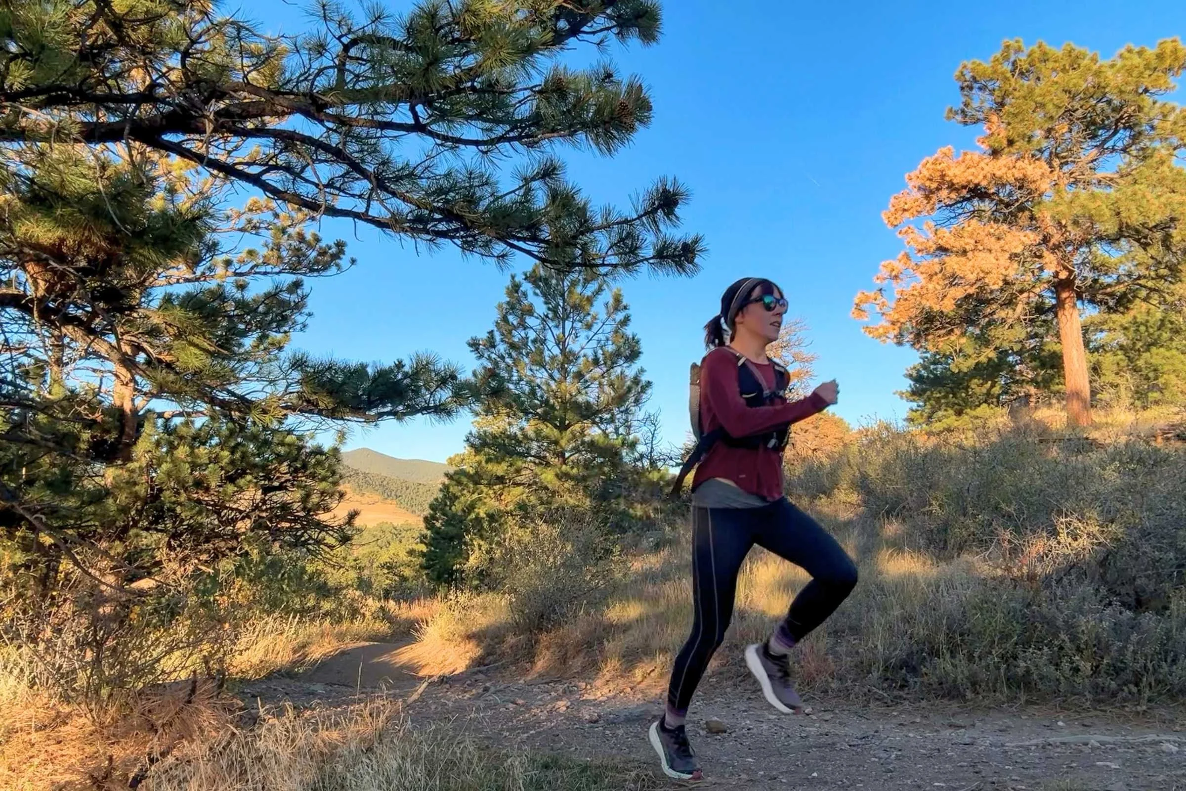   Runner wearing Nathan HyperNight QuickStart 3.0 hydration pack during early morning run  