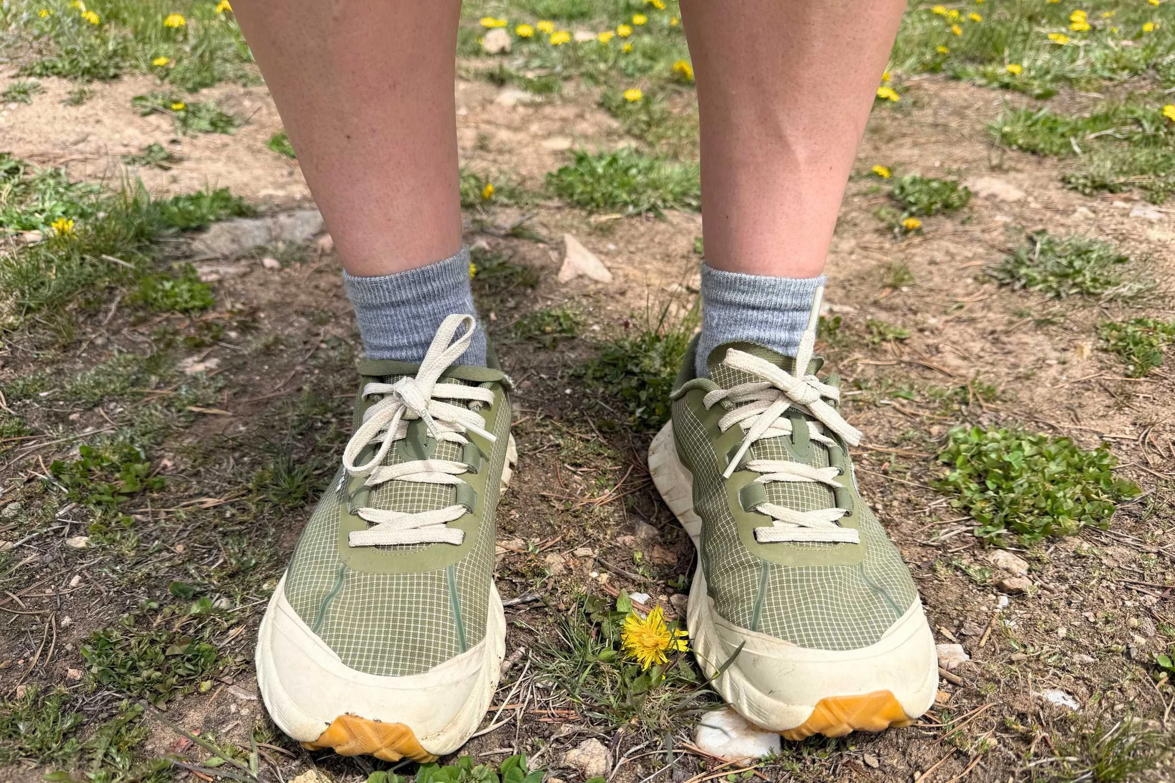   Front view of hiker wearing norda 002 trail running shoes on dirt trail  