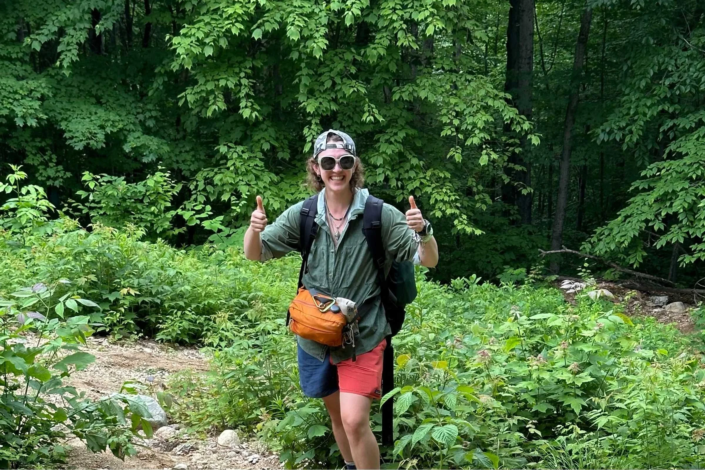   Hiker wearing Jolly Gear Triple Crown Button Down on forest trail with backpack and waist pack  