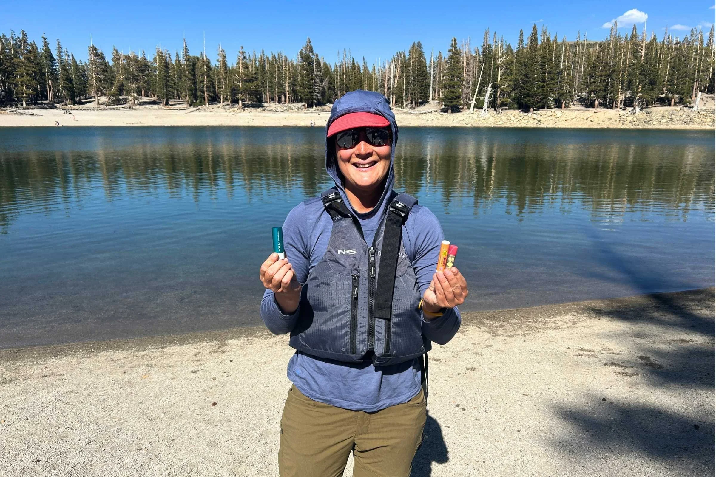   Woman wearing Smartwool Active UL Sun Hoodie beside alpine lake  