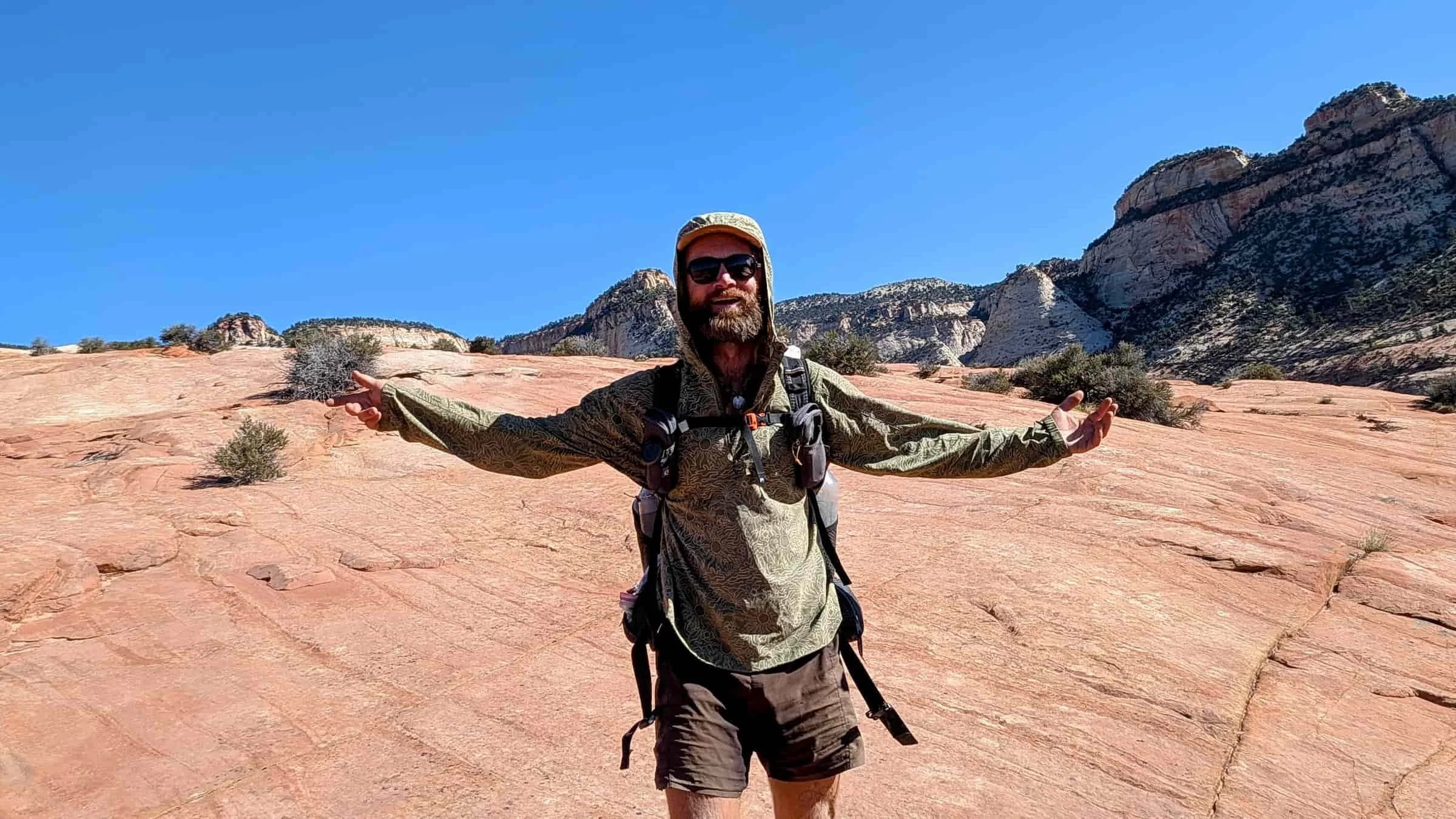   Person wearing Royal Robbins Salathe Sun Shirt while hiking on red rock terrain  