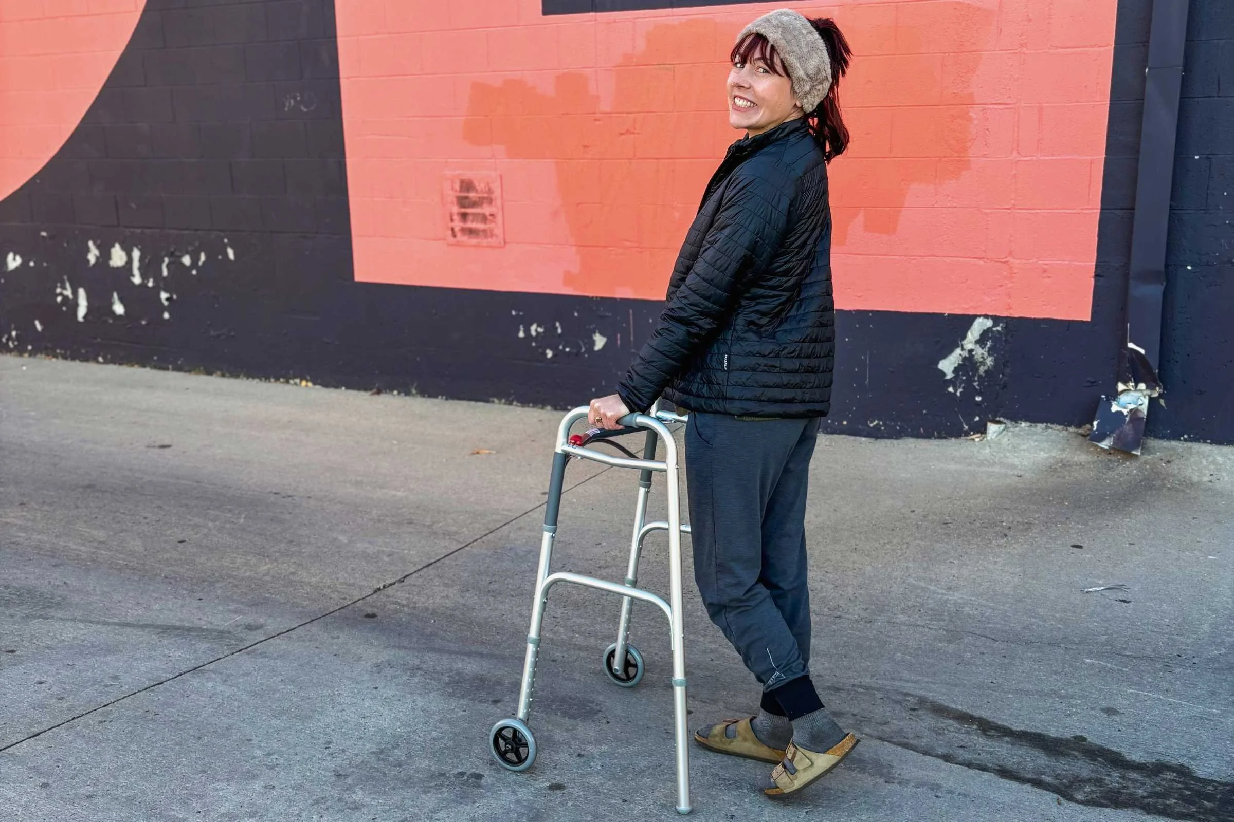   Person wearing Birkenstock Arizona Soft Footbed sandals while using a walker in an urban setting  